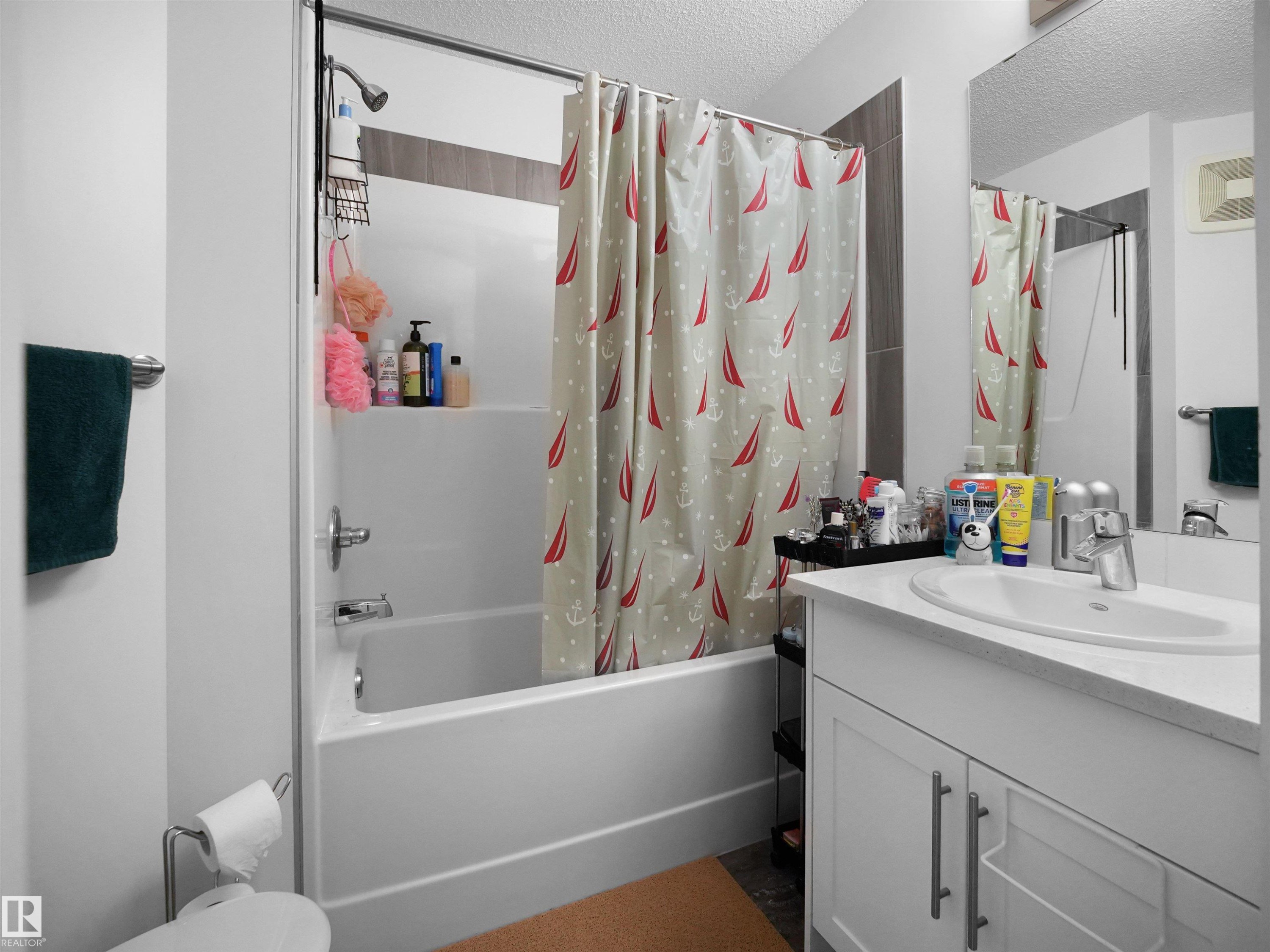 Bathroom featuring a white vanity with a white countertop and a white under-mount sink - 64 655 Watt Boulevard, Edmonton, AB - Indoor Photo Showing Bathroom