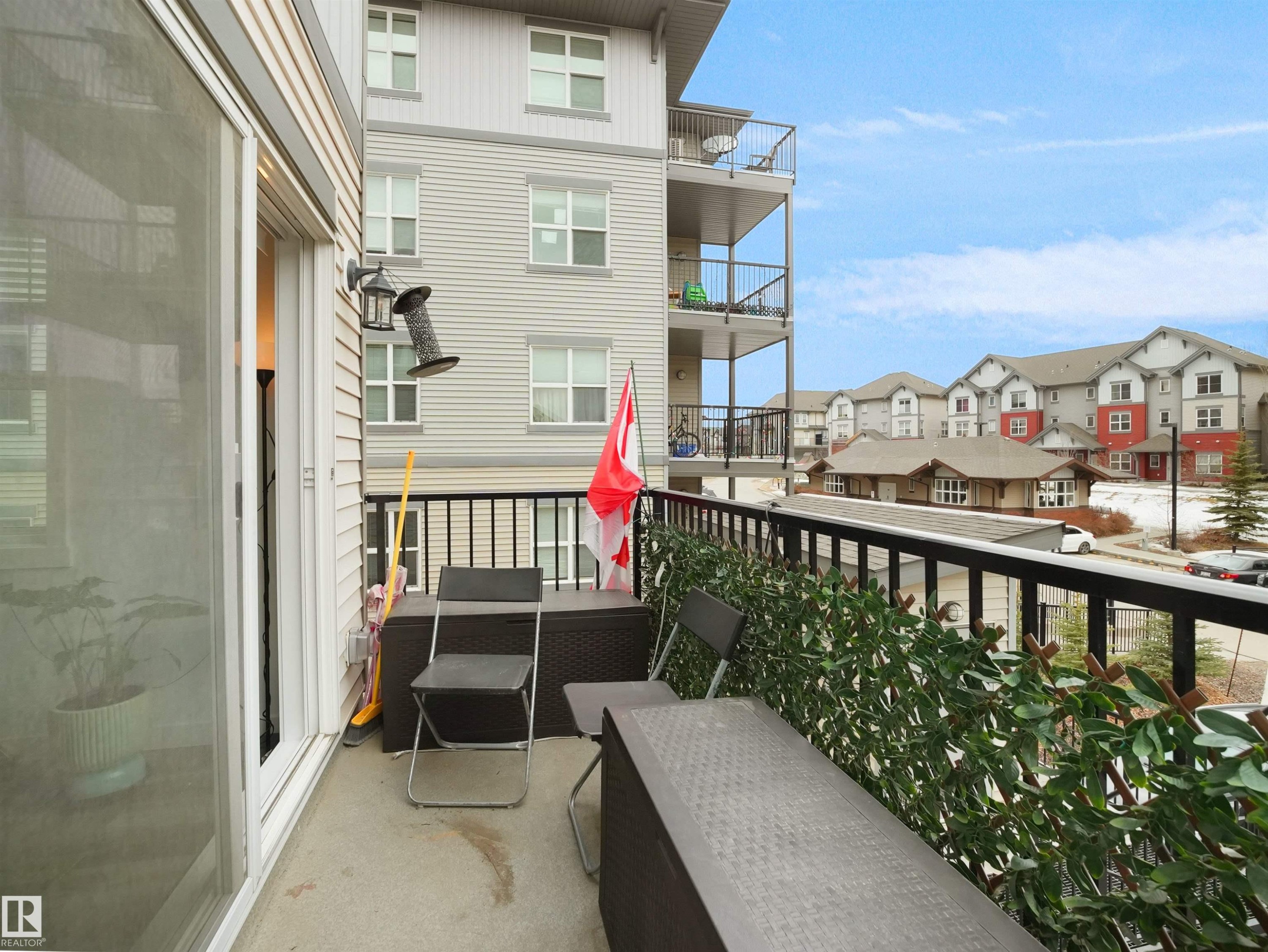 This property features a balcony with a concrete floor and a black metal railing - 64 655 Watt Boulevard, Edmonton, AB - Outdoor With Exterior