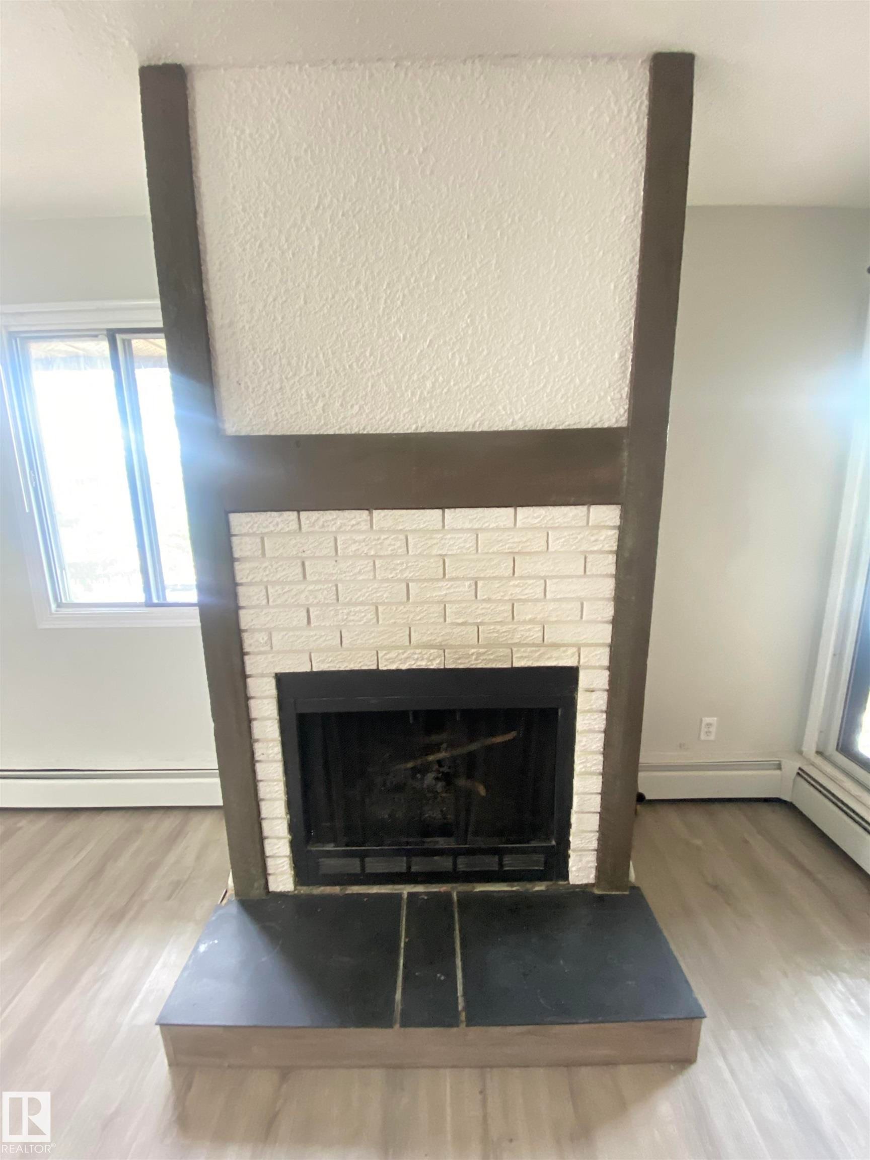 302 10826 113 Street, Edmonton, AB - Indoor Photo Showing Living Room With Fireplace