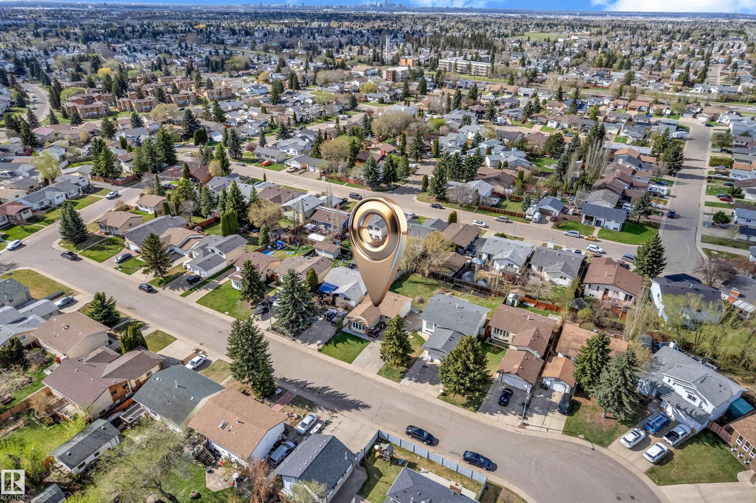 Aerial perspective showcasing a residential neighborhood with numerous single-family homes, mature trees, and paved streets - 3520 19 Avenue, Edmonton, AB