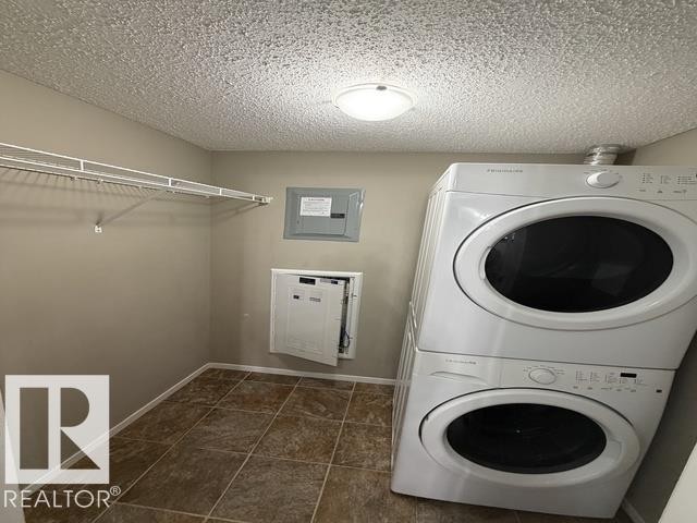 Laundry area featuring tile flooring, neutral wall paint, and overhead lighting - 321 107 Watt Common, Edmonton, AB - Indoor Photo Showing Laundry Room