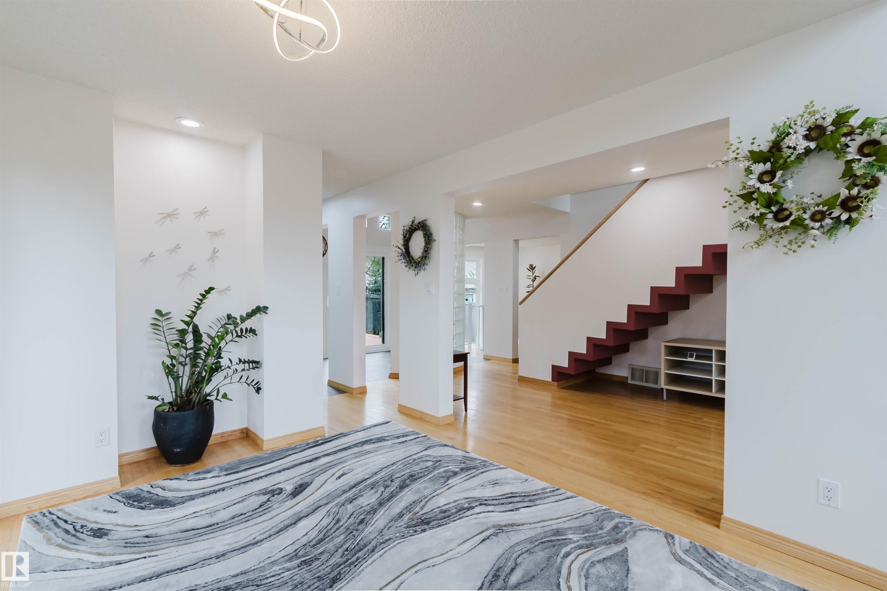 Interior architectural features include a contemporary staircase with red-finished risers, light wood-finish flooring, and recessed ceiling lighting - 342 O'Connor Close, Edmonton, AB - Indoor