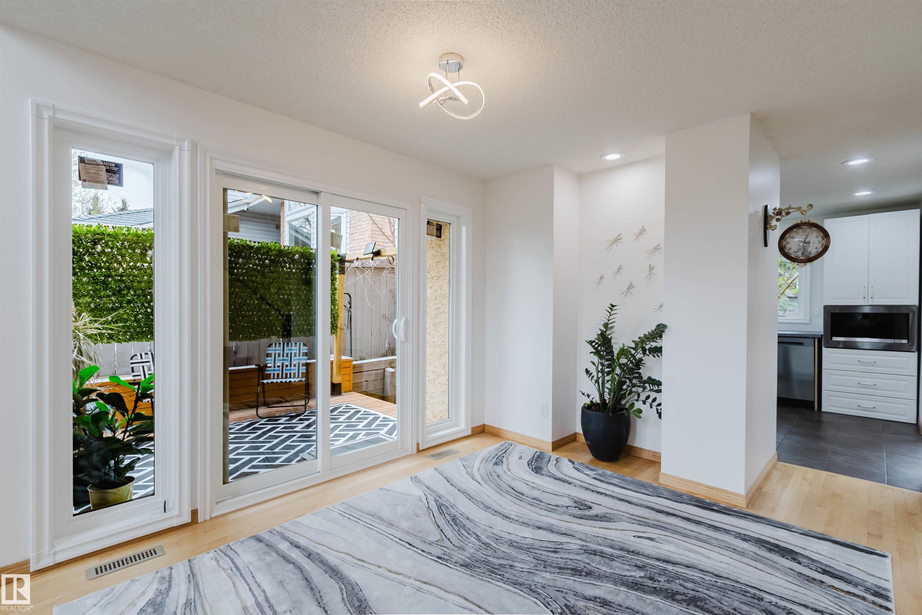 Hardwood-finish flooring extending from the living area into the adjacent space - 342 O'Connor Close, Edmonton, AB - Indoor Photo Showing Bedroom