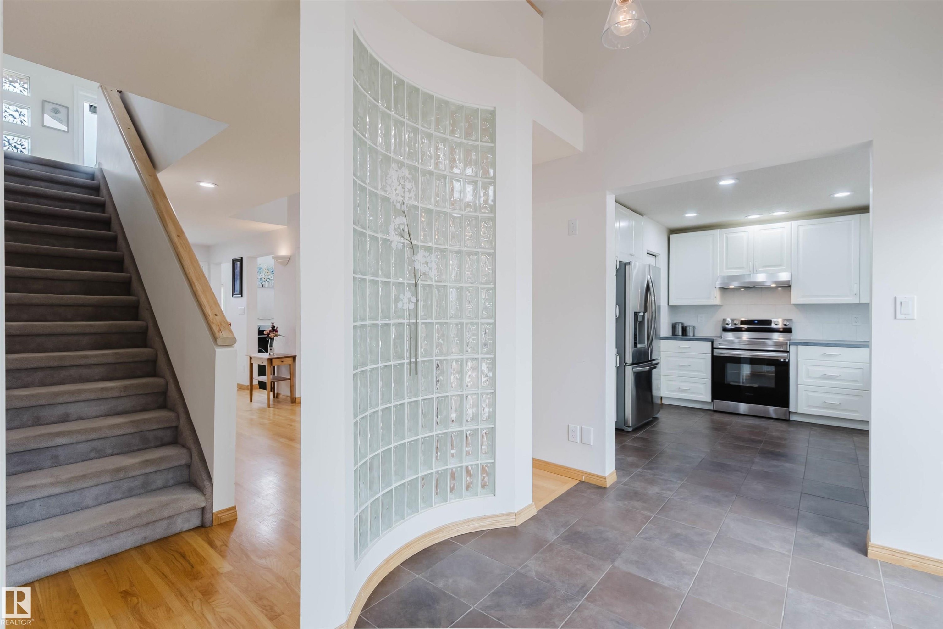 Kitchen featuring stainless steel appliances, white cabinetry, and light countertops - 342 O'Connor Close, Edmonton, AB - Indoor