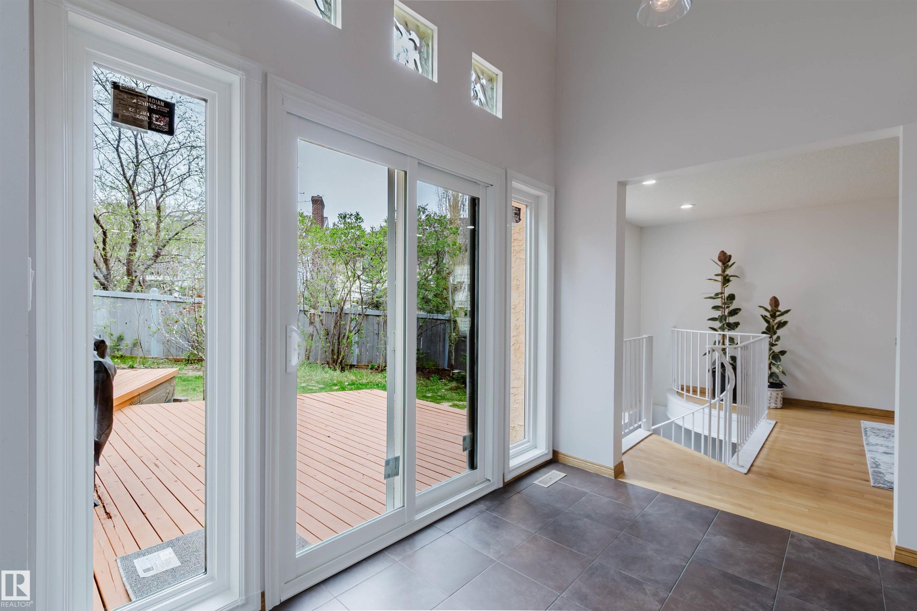 Sliding glass doors opening to an exterior wood-finish deck - 342 O'Connor Close, Edmonton, AB - Indoor Photo Showing Other Room