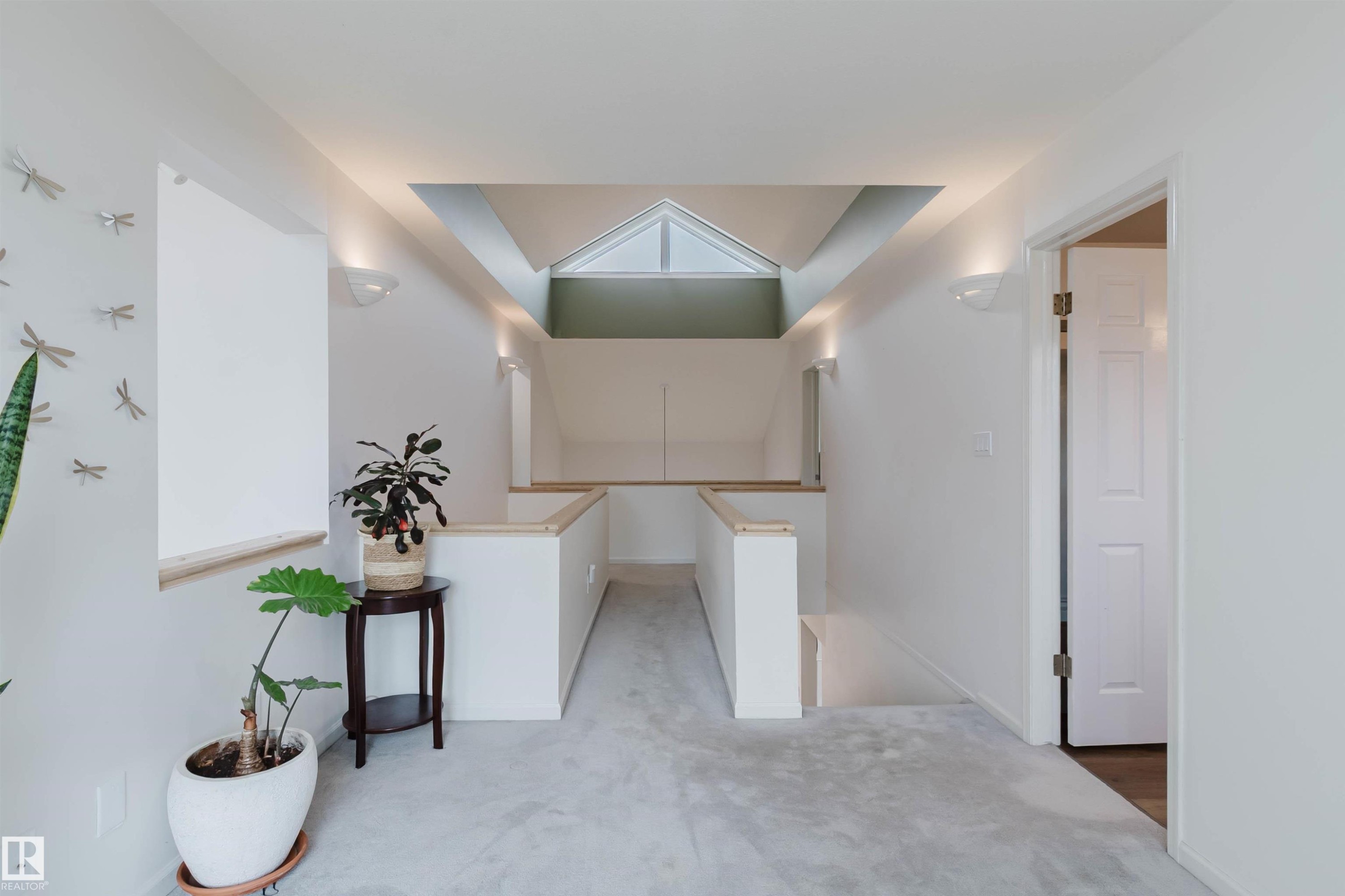 Upper-level landing featuring a vaulted ceiling with skylight, recessed lighting, wall sconces, and light wood-finish railings - 342 O'Connor Close, Edmonton, AB - Indoor Photo Showing Other Room