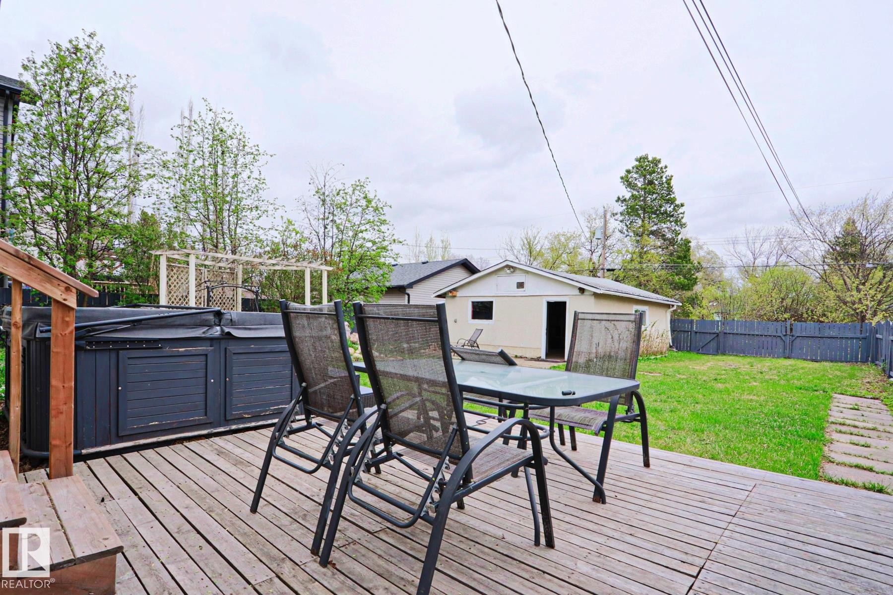 Wood-finish deck featuring a built-in spa - 9523 151 Street, Edmonton, AB - Outdoor With Deck Patio Veranda With Exterior