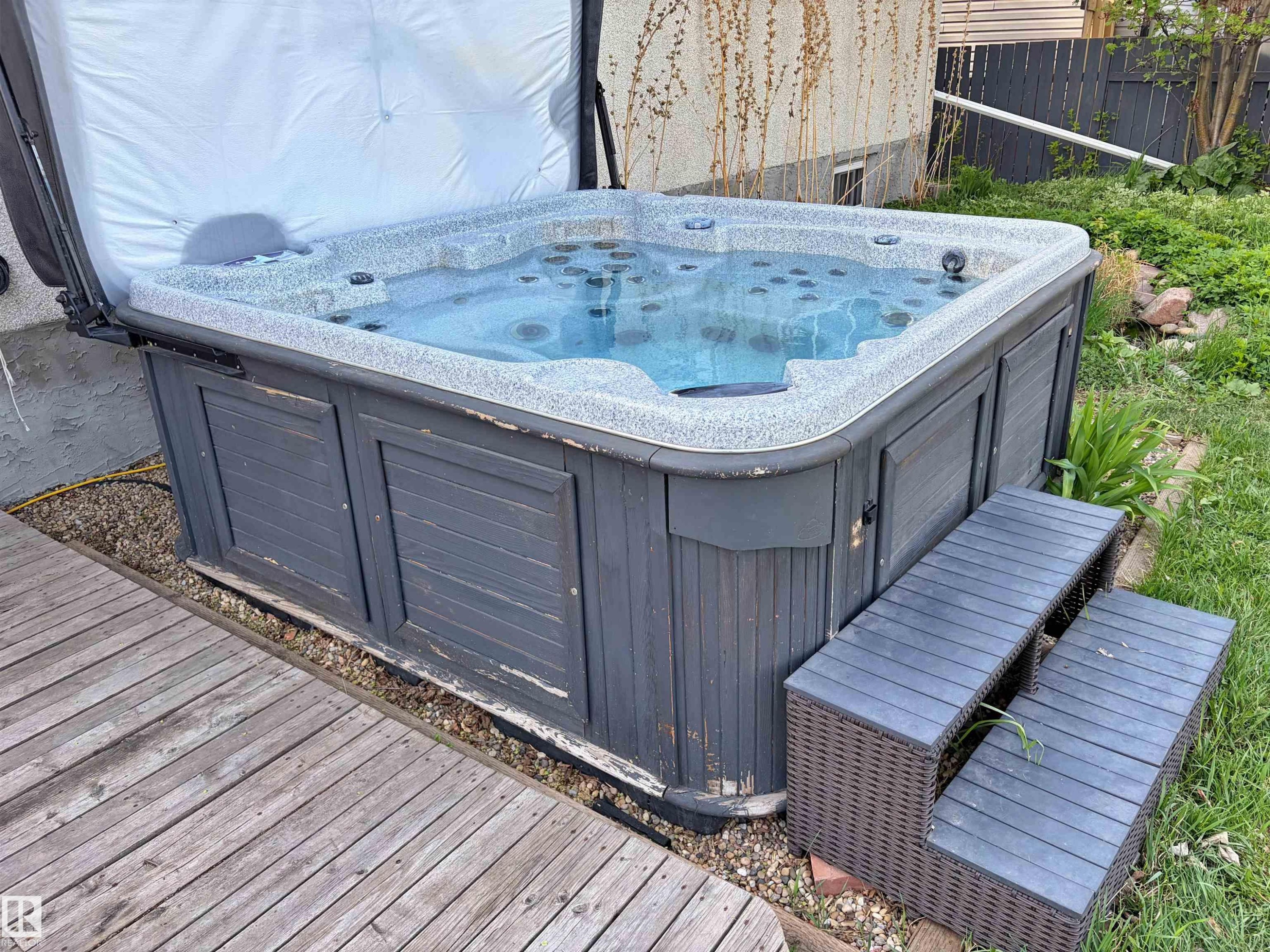 Outdoor hot tub featuring a slatted grey surround and a two-step entry - 9523 151 Street, Edmonton, AB - Outdoor With Deck Patio Veranda With Exterior