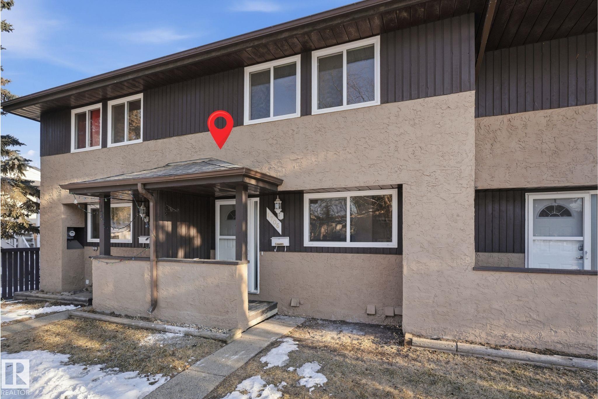 Two-story exterior with a covered porch entry, stucco lower facade, dark vertical siding on the upper level, and white frame windows - 1706 37 Street, Edmonton, AB - Outdoor