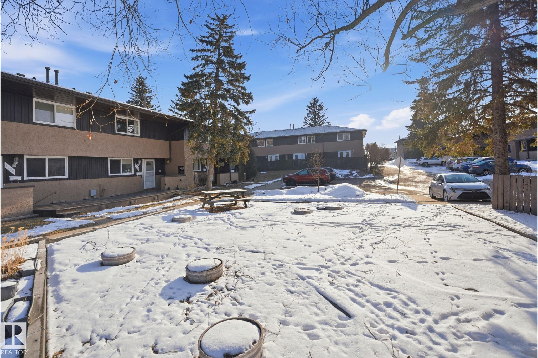 Two-story residential building with two-tone siding, multiple windows, and individual entrances - 1706 37 Street, Edmonton, AB - Outdoor