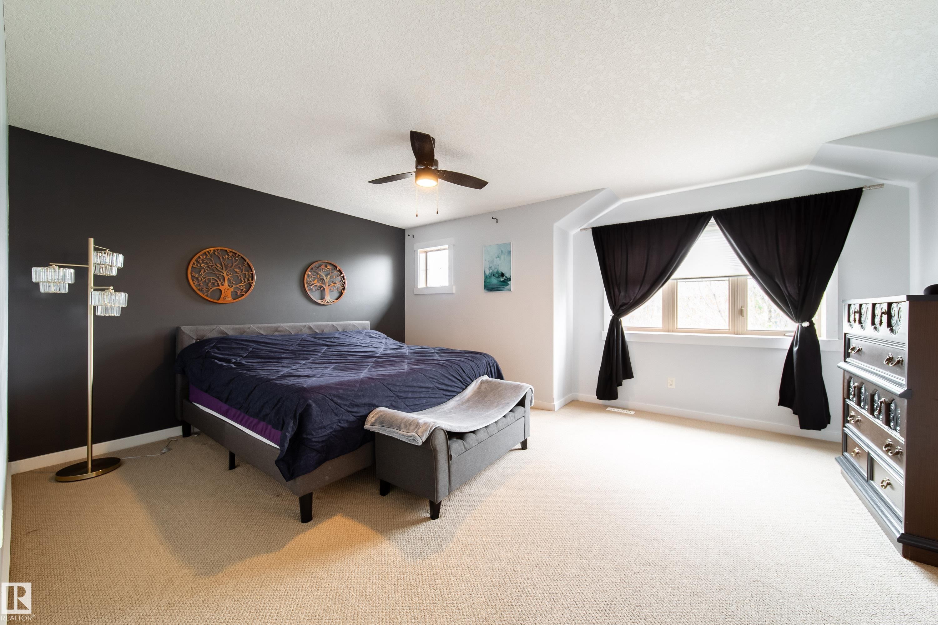 Room featuring a ceiling fan, a window with an alcove, and neutral carpeting - 2016 125 Street, Edmonton, AB - Indoor Photo Showing Bedroom