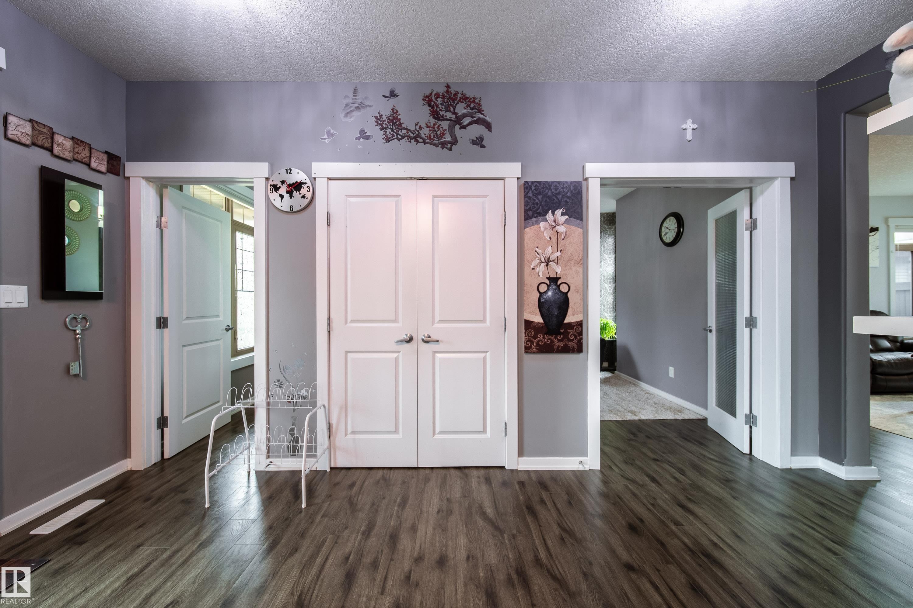 Wood-finish flooring extending throughout the space - 2016 125 Street, Edmonton, AB - Indoor Photo Showing Other Room