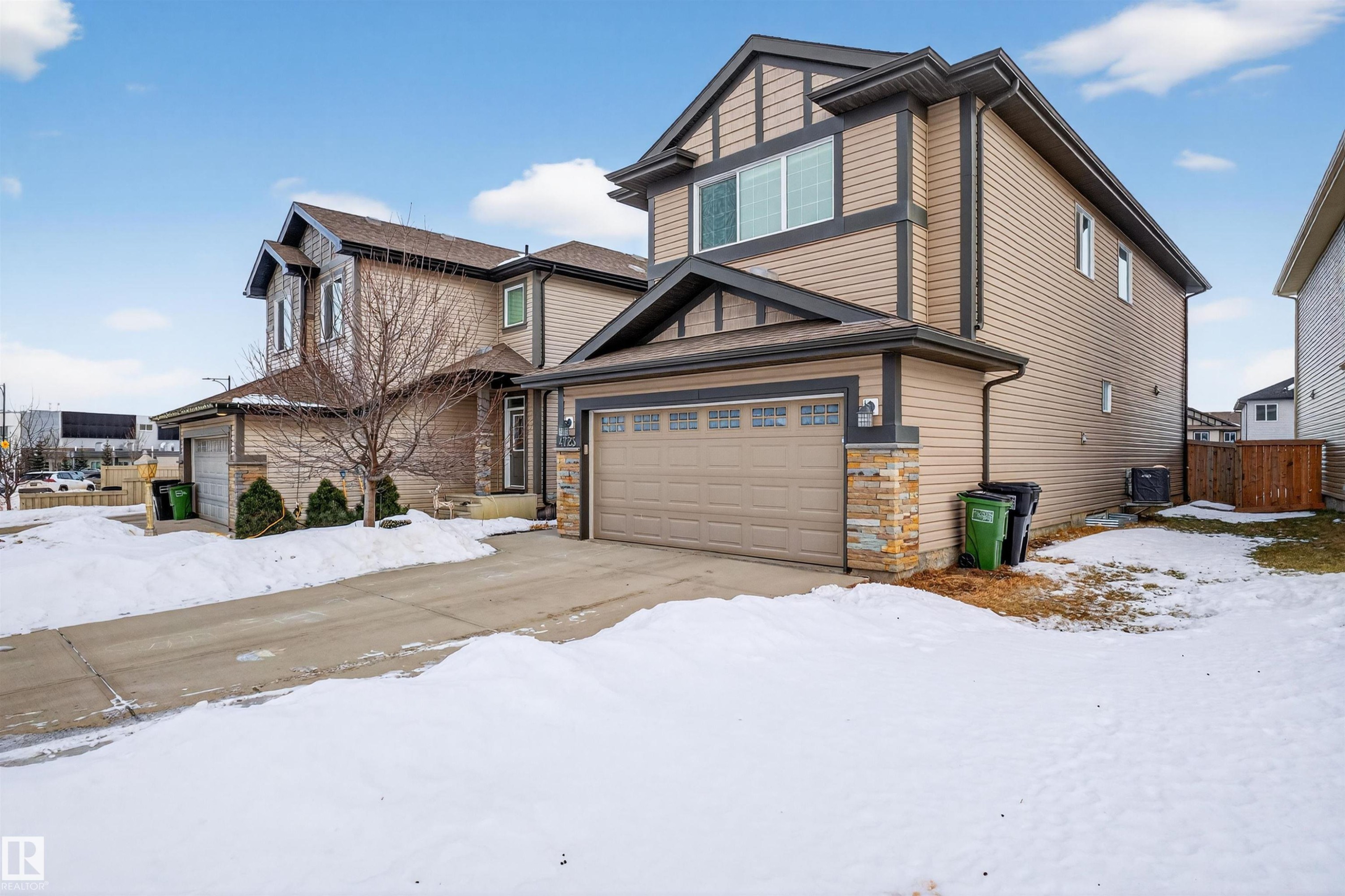 Contemporary two-story residence featuring tan siding and dark trim accents - 4723 Alwood Bend Sw, Edmonton, AB - Outdoor
