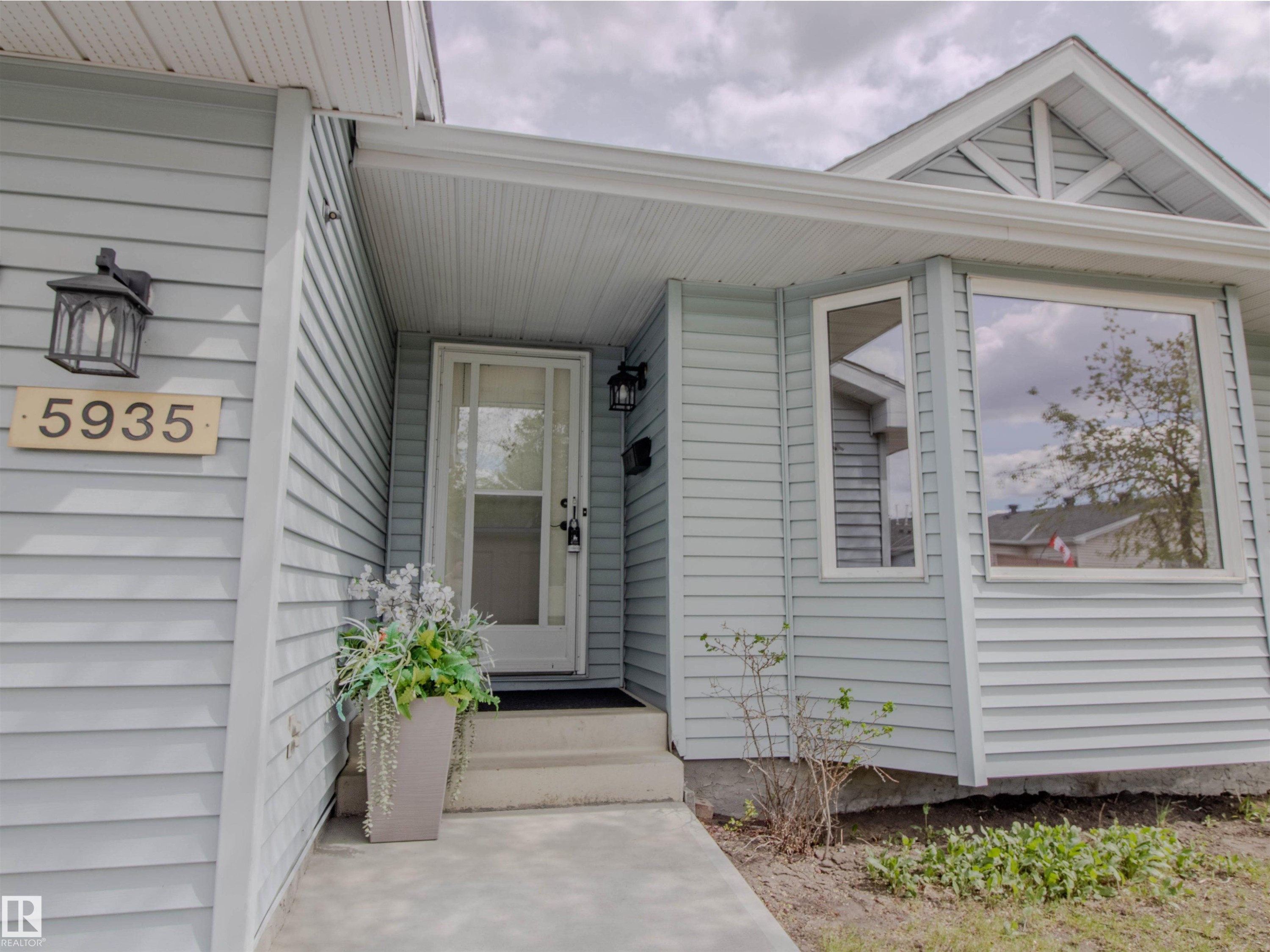 Light blue horizontal siding exterior with a white trim package - 5935 189 Street, Edmonton, AB - Outdoor