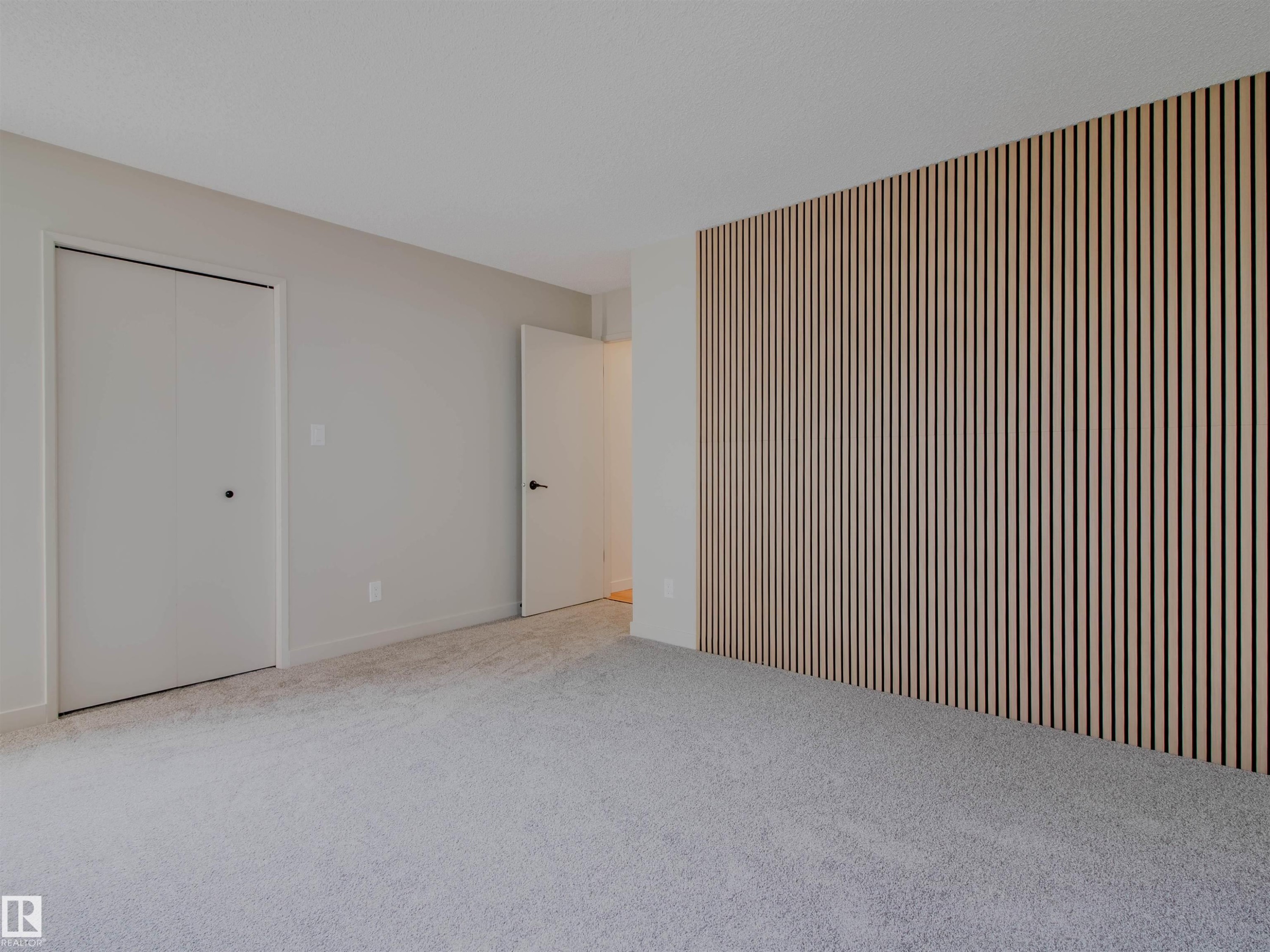 Accent wall featuring vertical wood paneling - 5935 189 Street, Edmonton, AB - Indoor Photo Showing Other Room