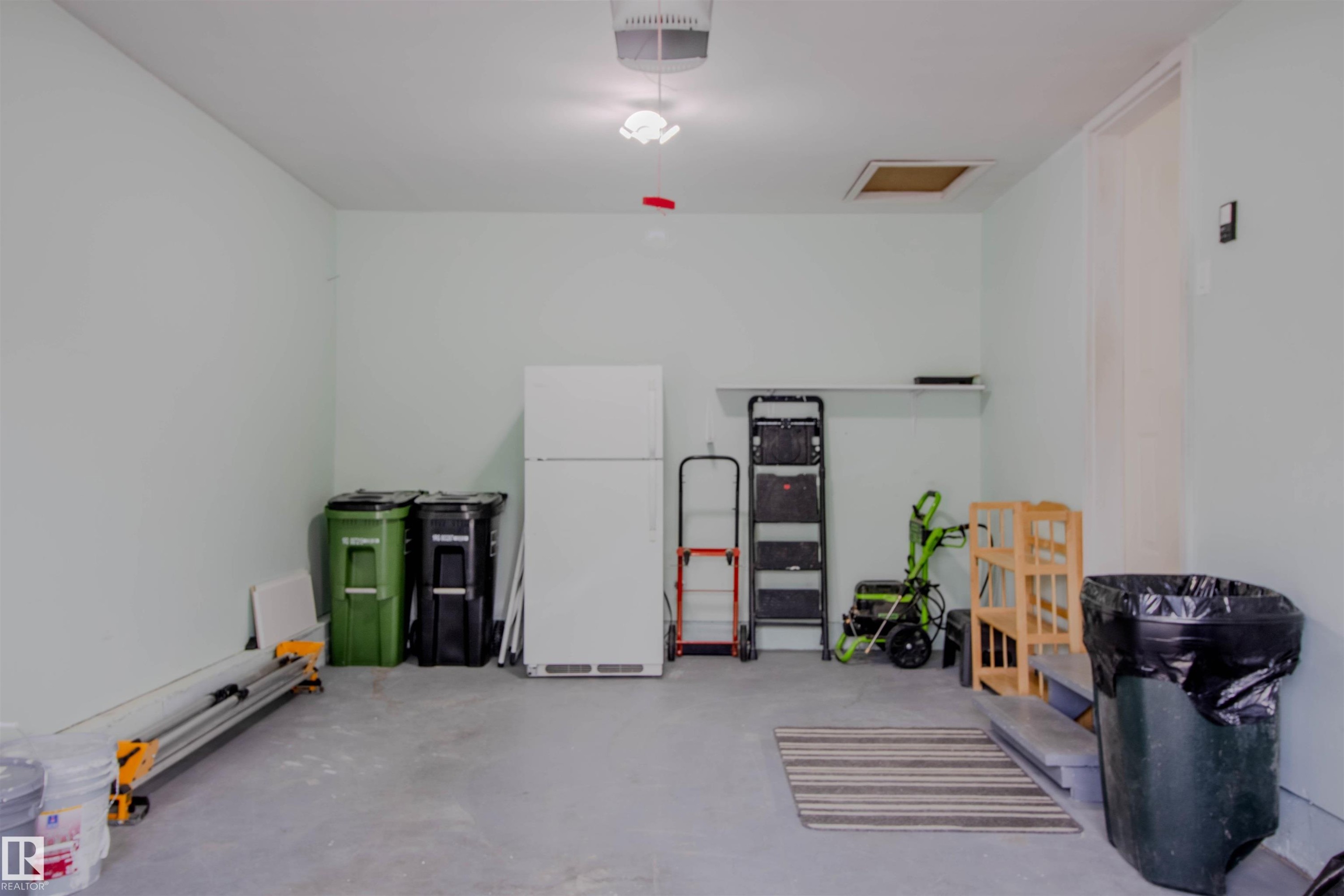 Spacious garage with light-toned walls and concrete flooring - 5935 189 Street, Edmonton, AB - Indoor Photo Showing Other Room