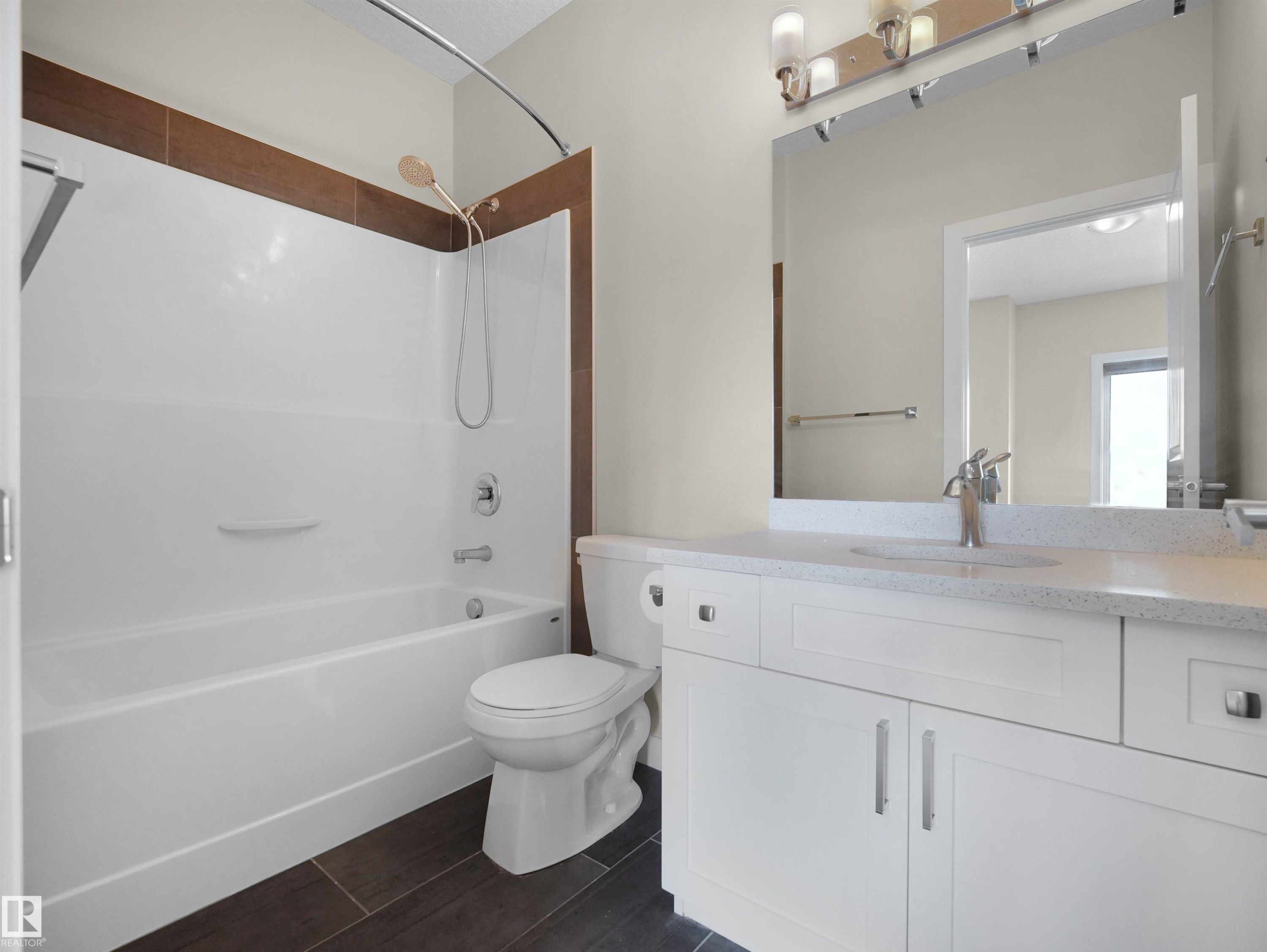Bathroom featuring a white vanity with a light-toned countertop, an integrated sink, and brushed nickel hardware - 8921 217 Street Nw, Edmonton, AB - Indoor Photo Showing Bathroom