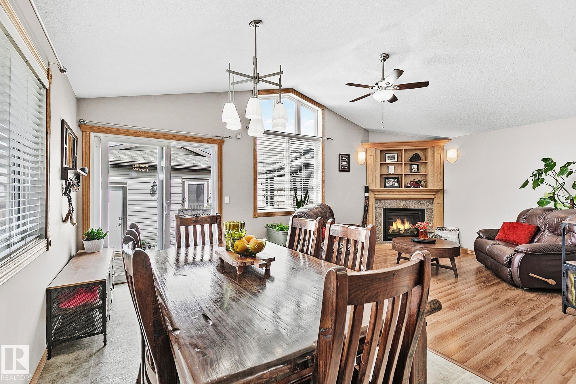 98 Hewitt Circle, Spruce Grove, AB - Indoor Photo Showing Dining Room With Fireplace
