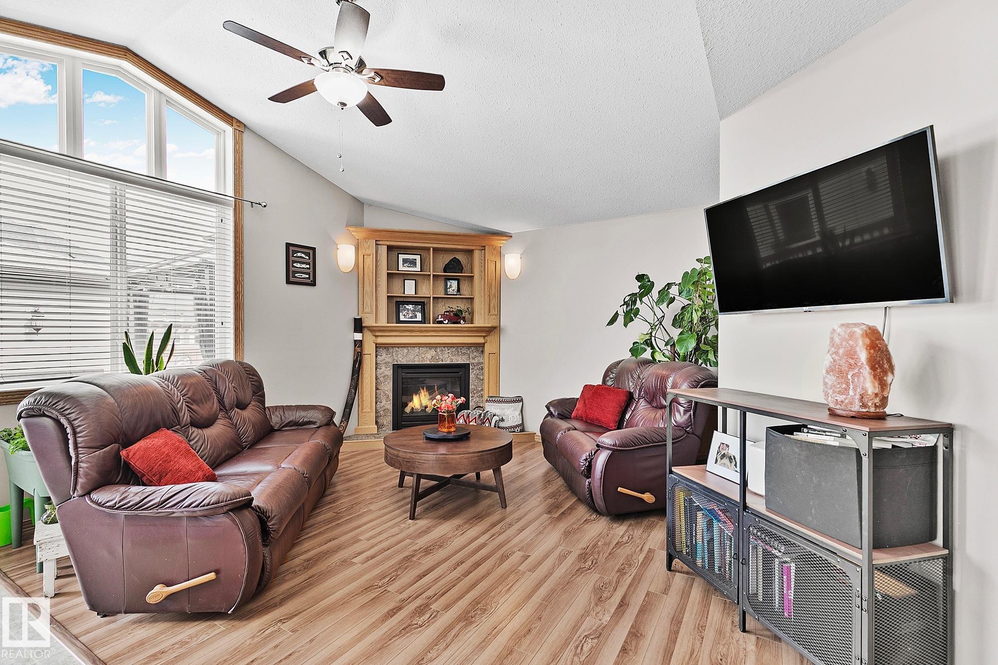 98 Hewitt Circle, Spruce Grove, AB - Indoor Photo Showing Living Room With Fireplace