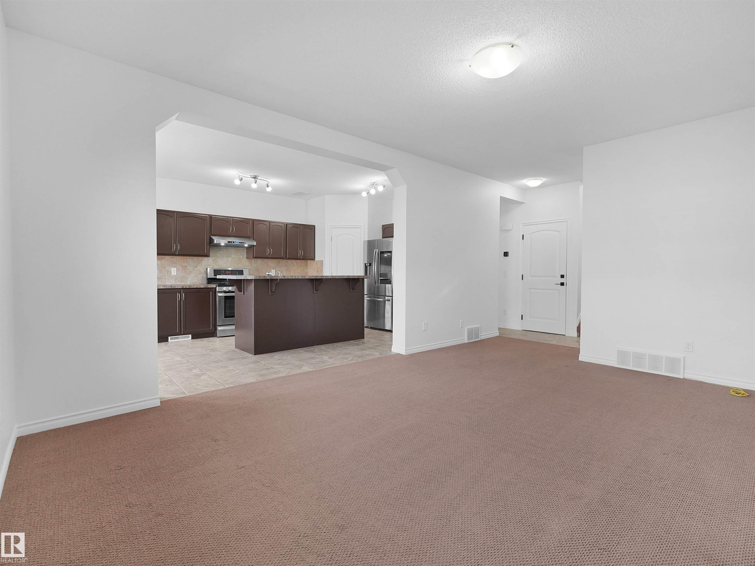 Spacious living area with carpet flooring - 2017 32A Street, Edmonton, AB - Indoor Photo Showing Kitchen