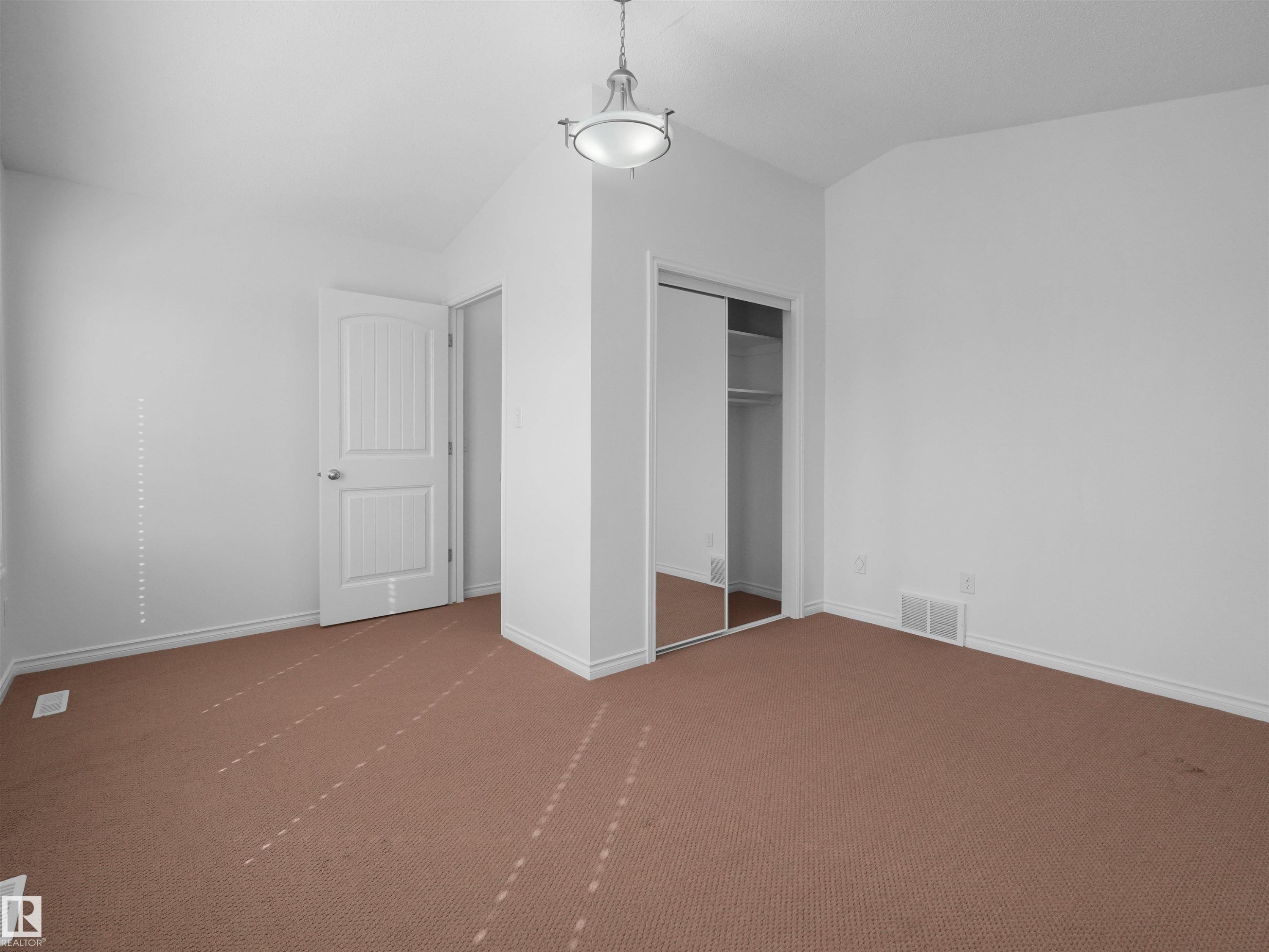 Spacious room featuring neutral white walls, brown carpeting, and white baseboards - 2017 32A Street, Edmonton, AB - Indoor Photo Showing Other Room