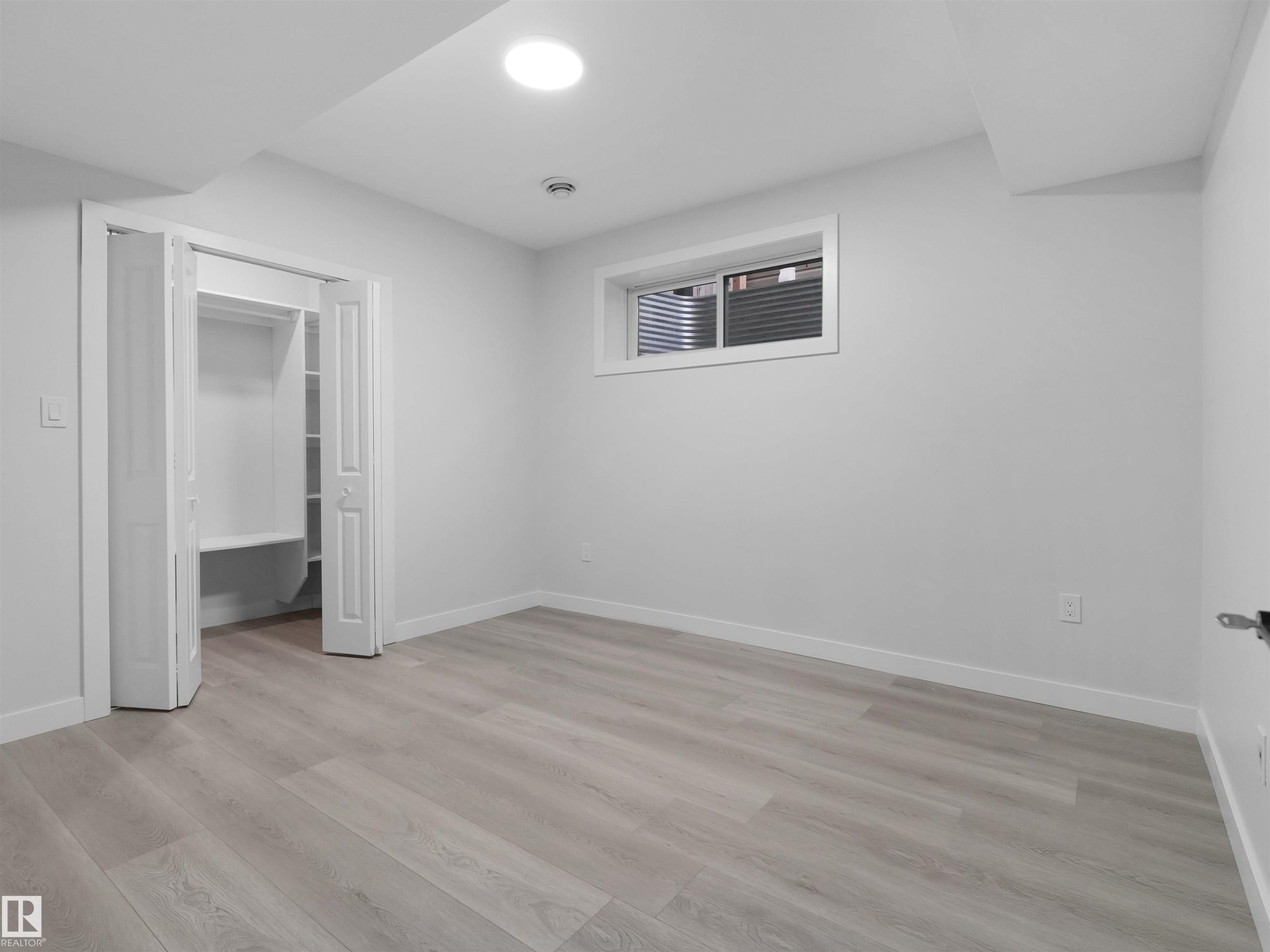 Room featuring light wood-finish flooring, white walls, and a recessed ceiling light - 2017 32A Street, Edmonton, AB - Indoor Photo Showing Other Room