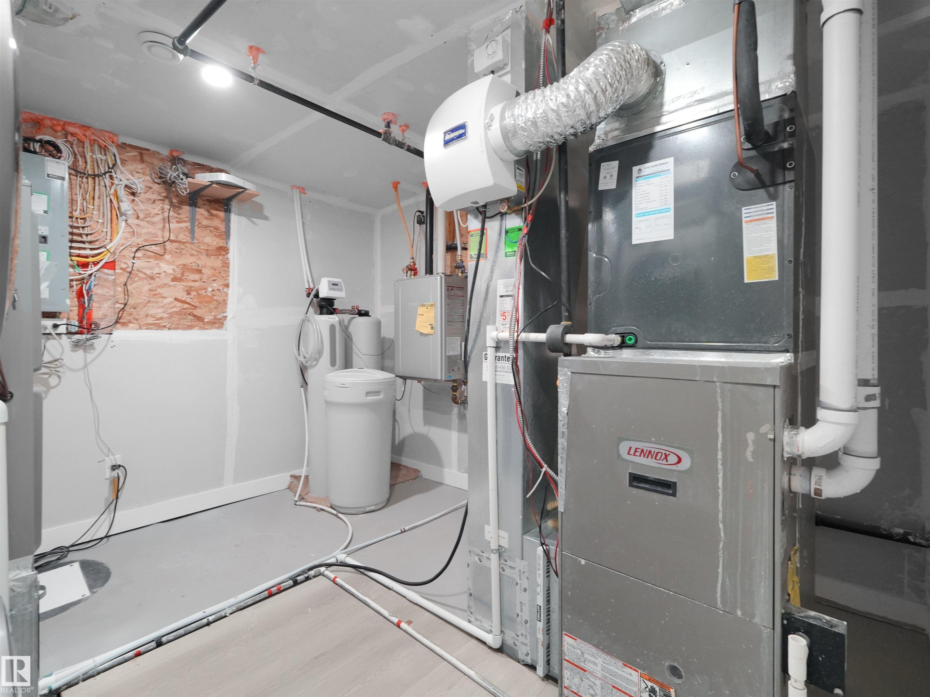 Utility area featuring a Lennox furnace, water heater, water softener, and electrical panel - 2017 32A Street, Edmonton, AB - Indoor Photo Showing Basement