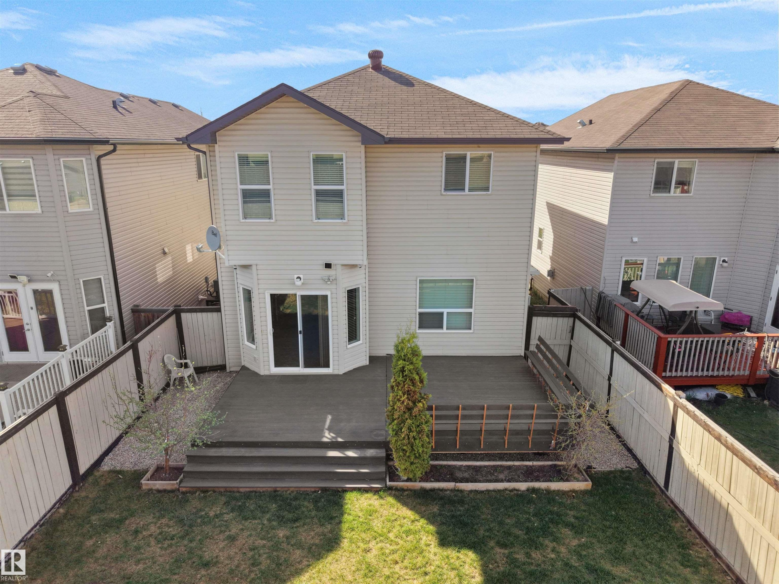 Rear exterior with a spacious multi-level deck featuring a dark composite finish - 2017 32A Street, Edmonton, AB - Outdoor