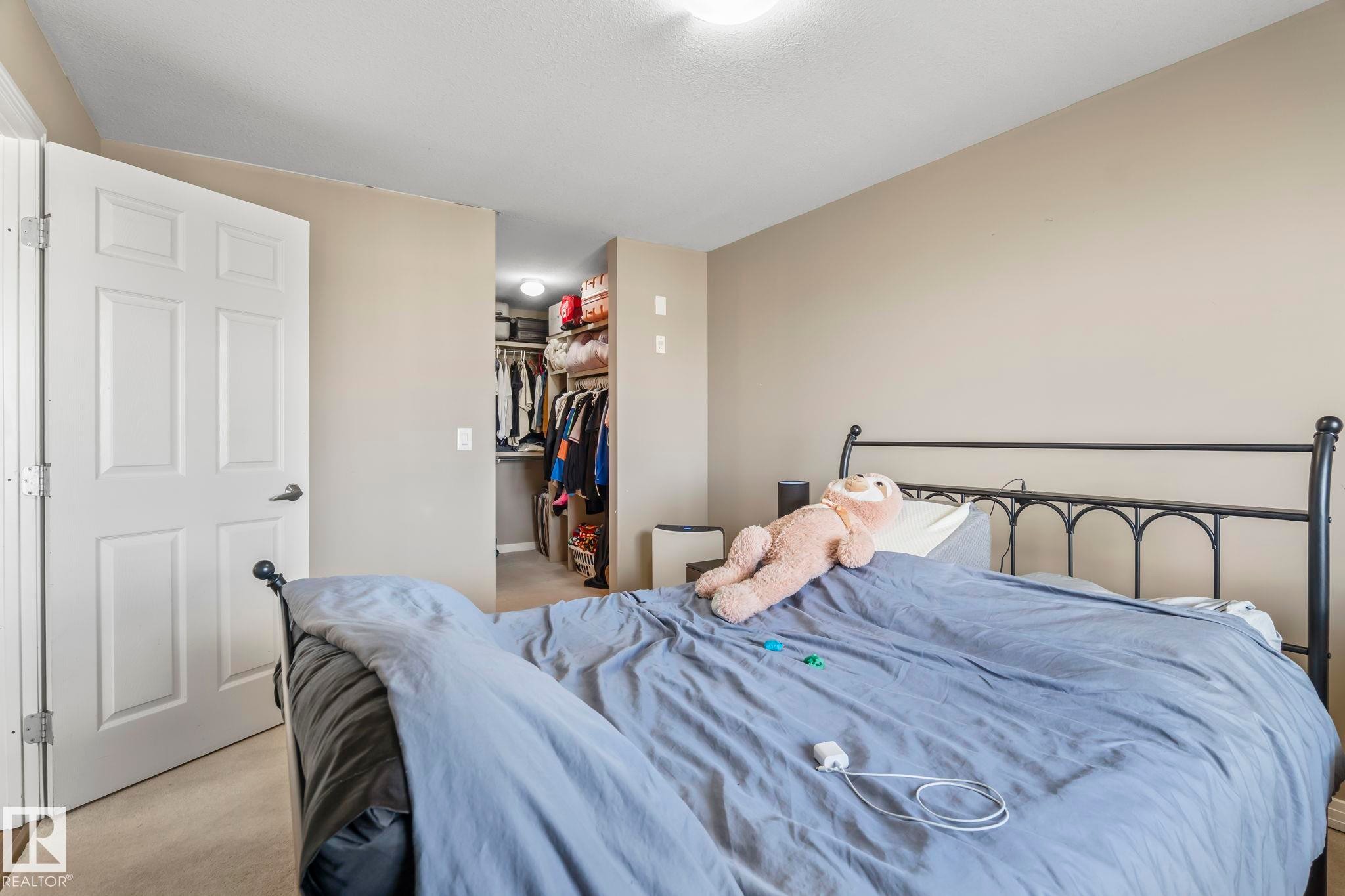 Bedroom with neutral wall paint and carpet flooring - 412 5005 165 Avenue Nw, Edmonton, AB - Indoor Photo Showing Bedroom
