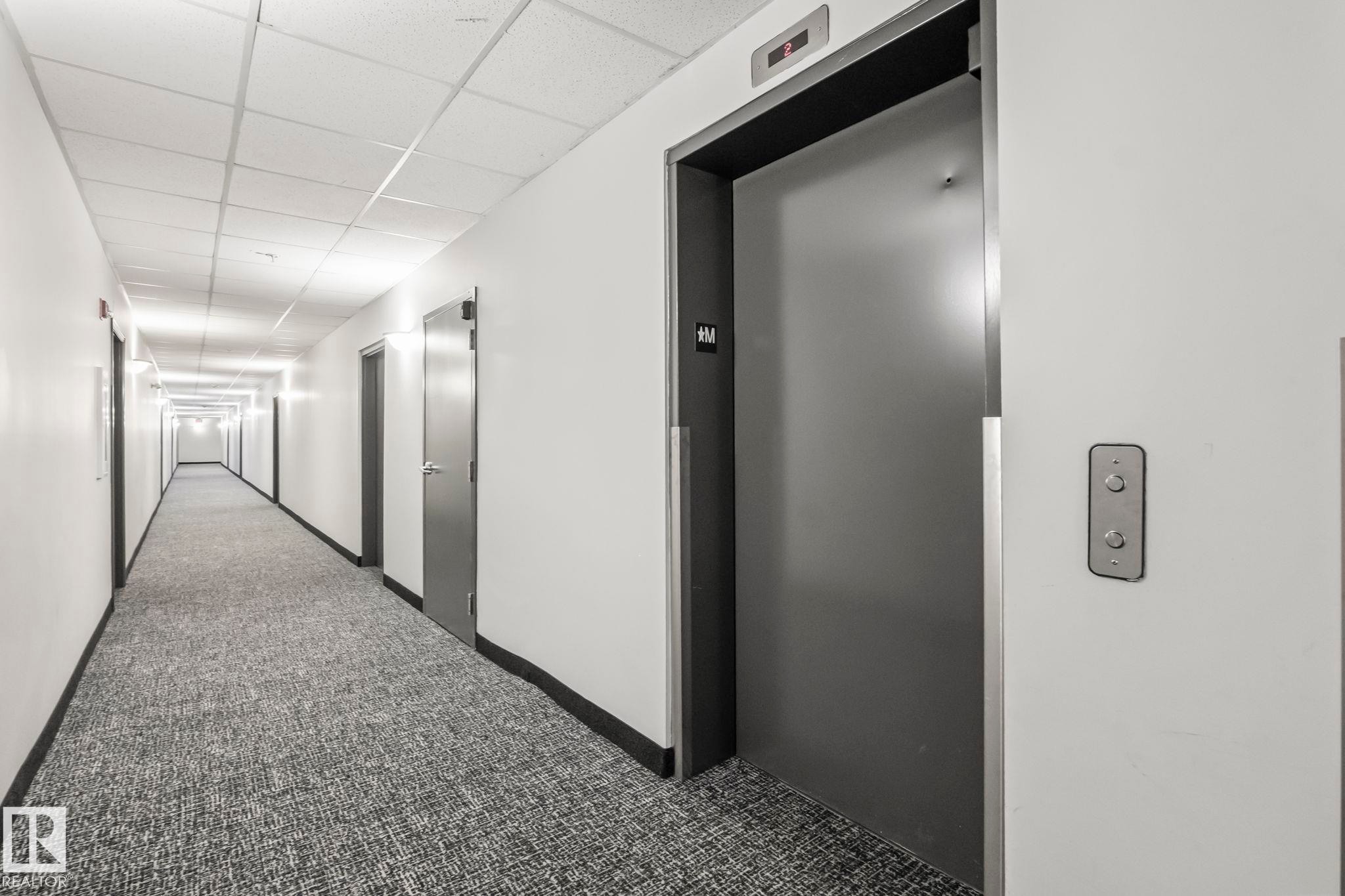 Hallway with patterned carpeting, recessed lighting, and white walls - 412 5005 165 Avenue Nw, Edmonton, AB - Indoor Photo Showing Other Room
