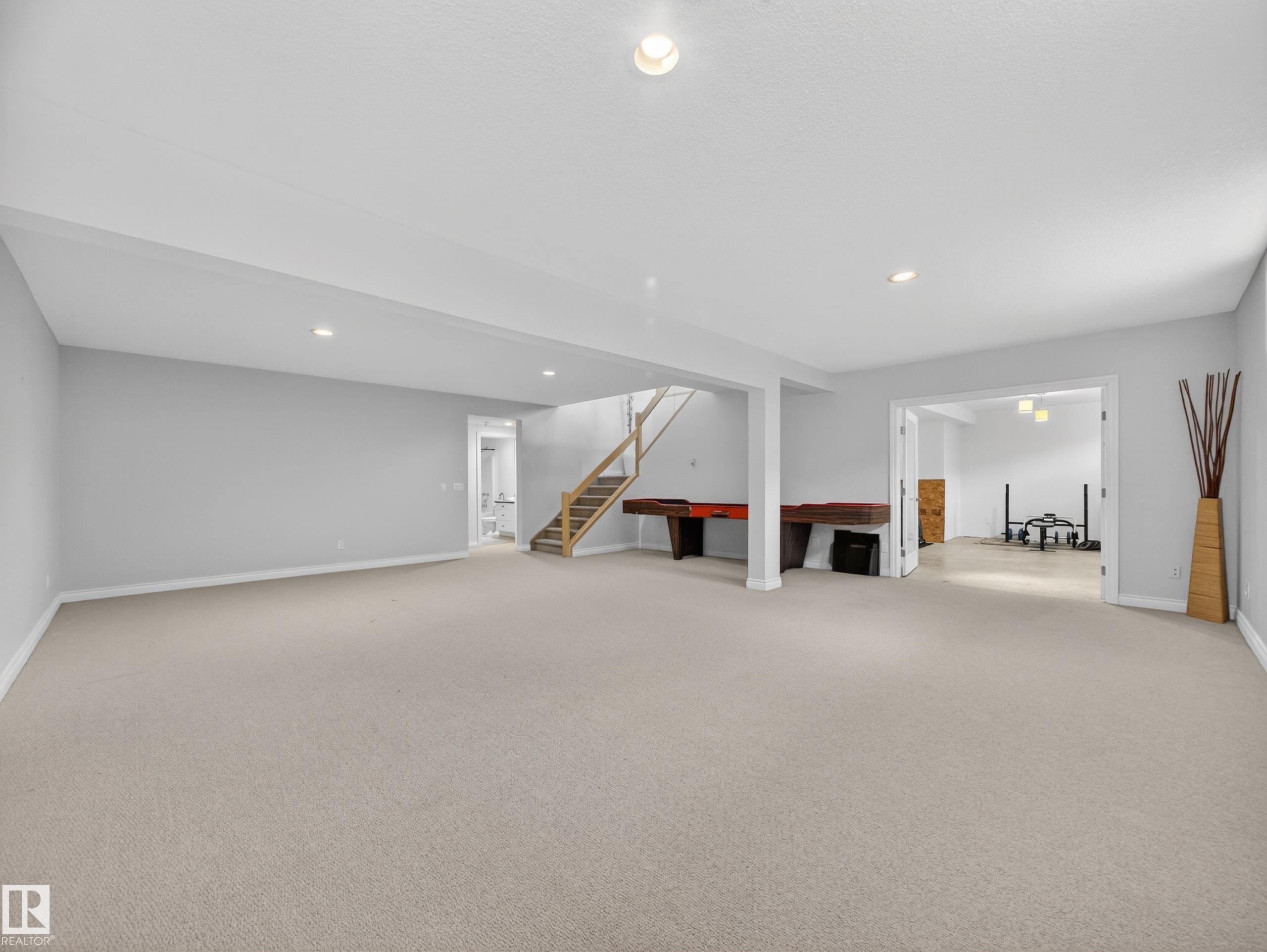 Carpeted open-concept lower level with recessed lighting and light gray wall paint - 569 Butterworth Way, Edmonton, AB - Indoor Photo Showing Other Room