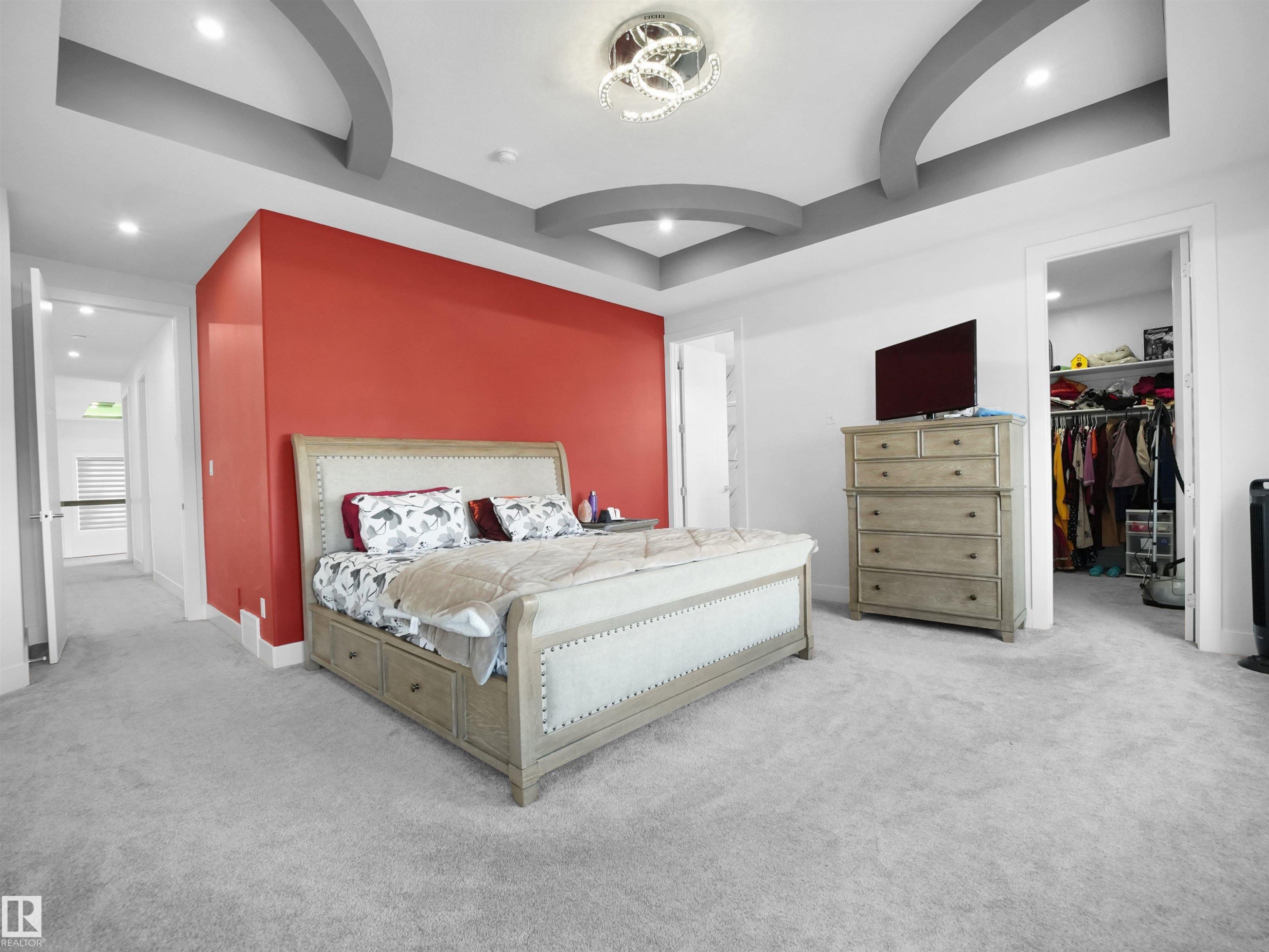 Spacious room featuring light gray carpeting and a tray ceiling with integrated lighting - 1208 25 St Nw, Edmonton, AB - Indoor Photo Showing Bedroom