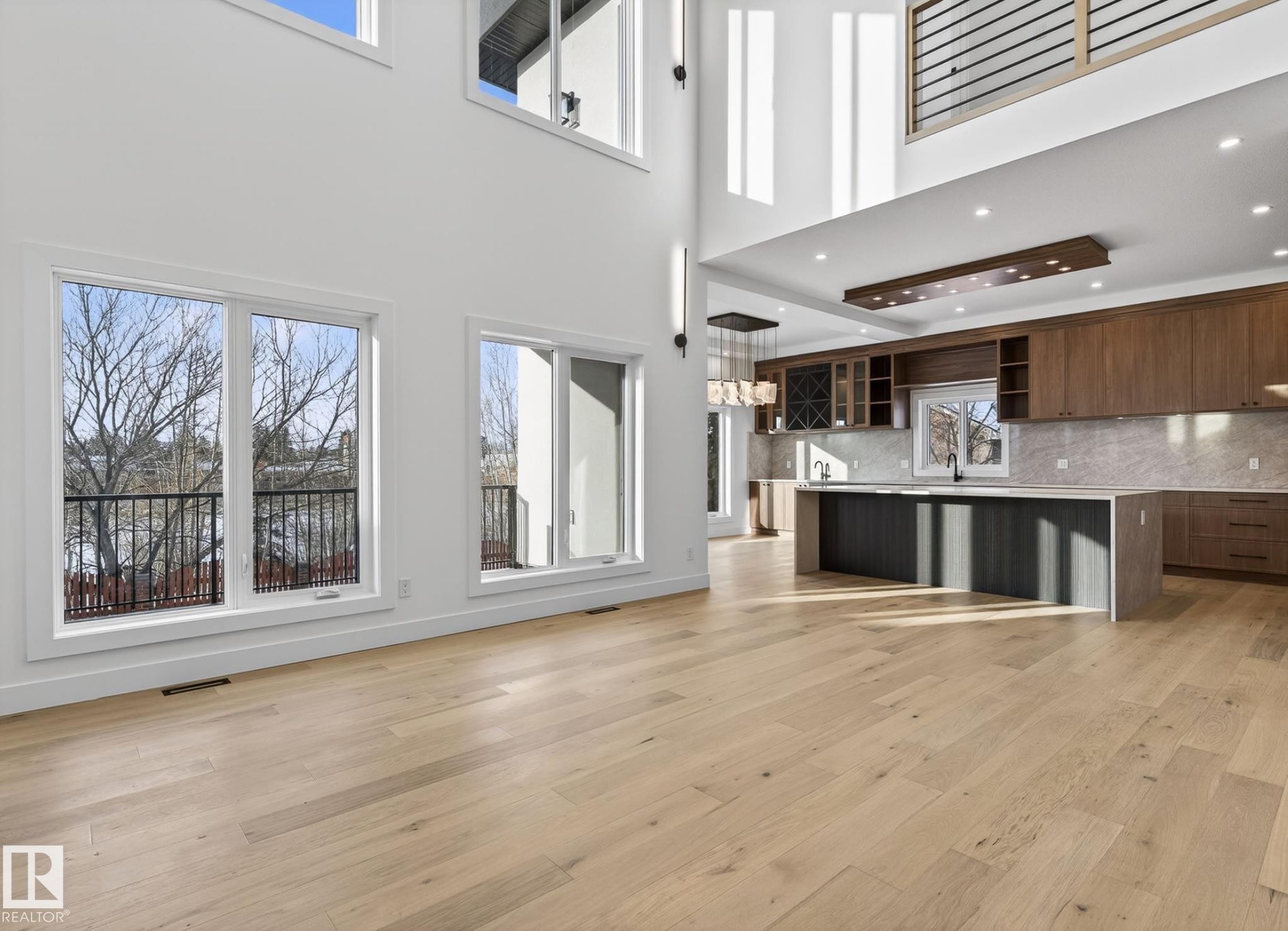 Vaulted ceilings enhance this open-concept space featuring light wood-finish flooring - 5820 110 Street, Edmonton, AB - Indoor Photo Showing Kitchen