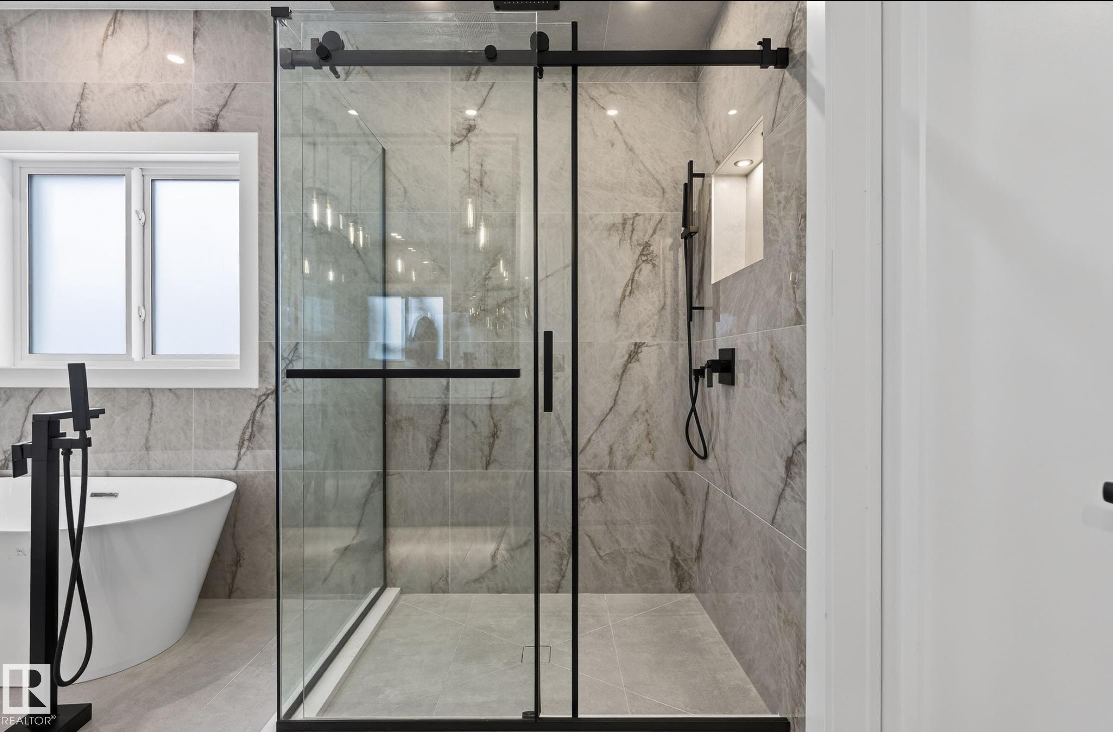 Contemporary shower enclosure with matte black hardware, full-height tile surround, built-in shower niche, and recessed lighting - 5820 110 Street, Edmonton, AB - Indoor Photo Showing Bathroom