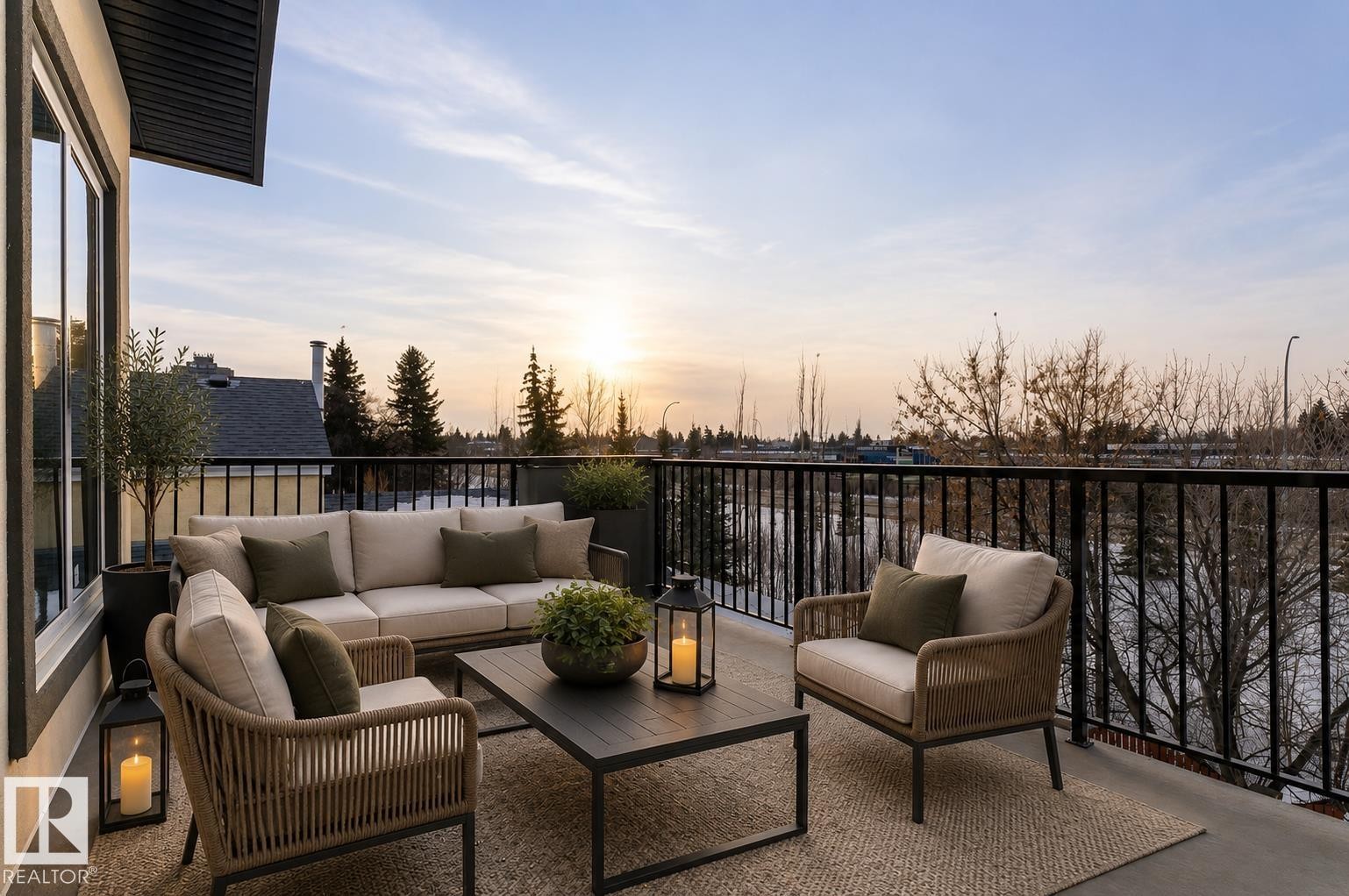 Expansive balcony featuring a black metal railing, concrete flooring, and a large window - 5820 110 Street, Edmonton, AB - Outdoor With Exterior