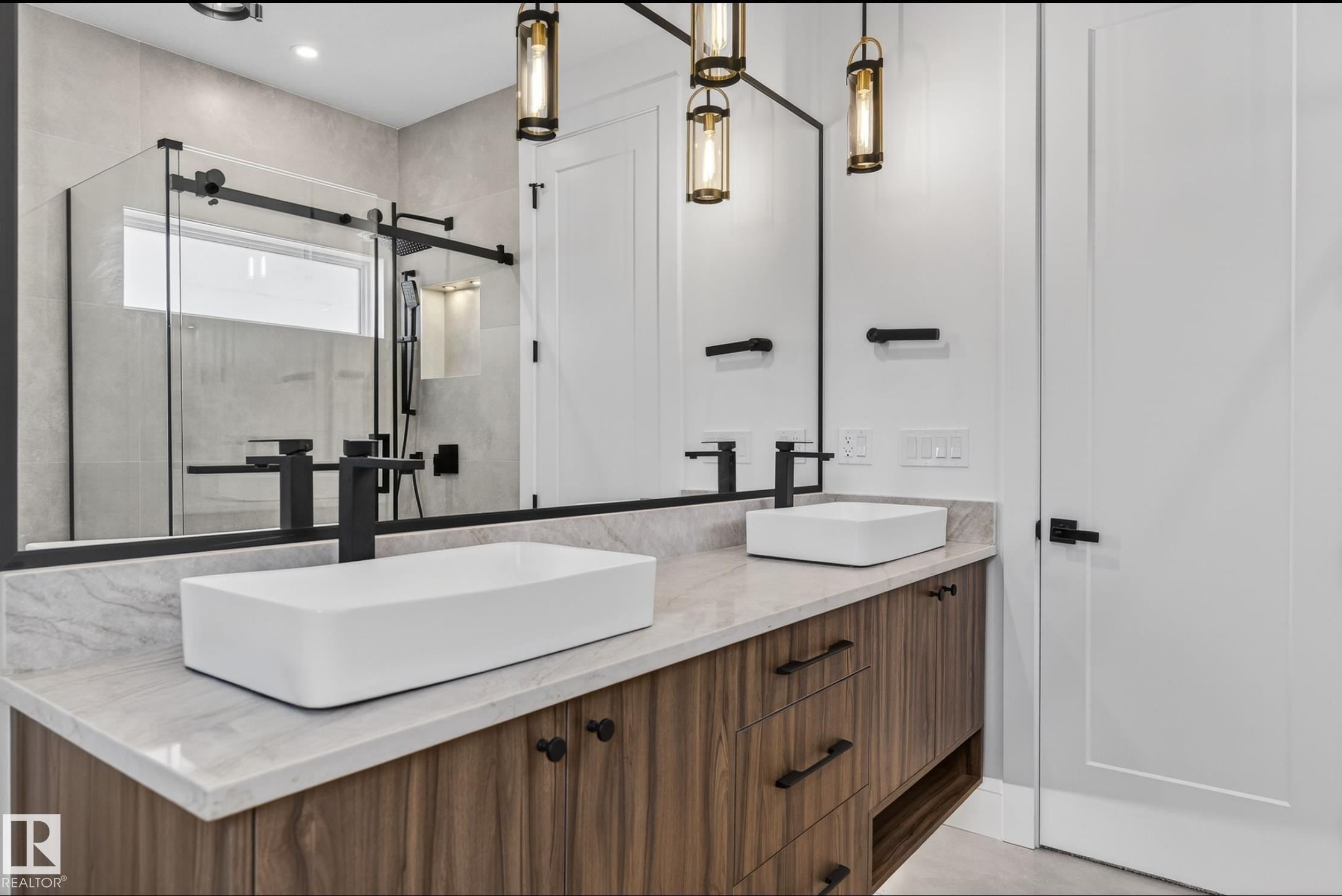 Modern bathroom featuring a dual vessel sink vanity with wood-finish cabinetry and a light-toned countertop - 5820 110 Street, Edmonton, AB - Indoor Photo Showing Bathroom
