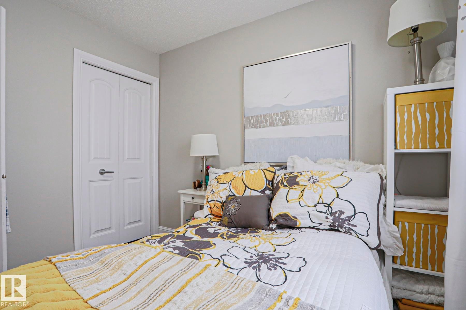 Neutral-toned walls complement white trim and a two-panel closet door - 1621 64 Street, Edmonton, AB - Indoor Photo Showing Bedroom
