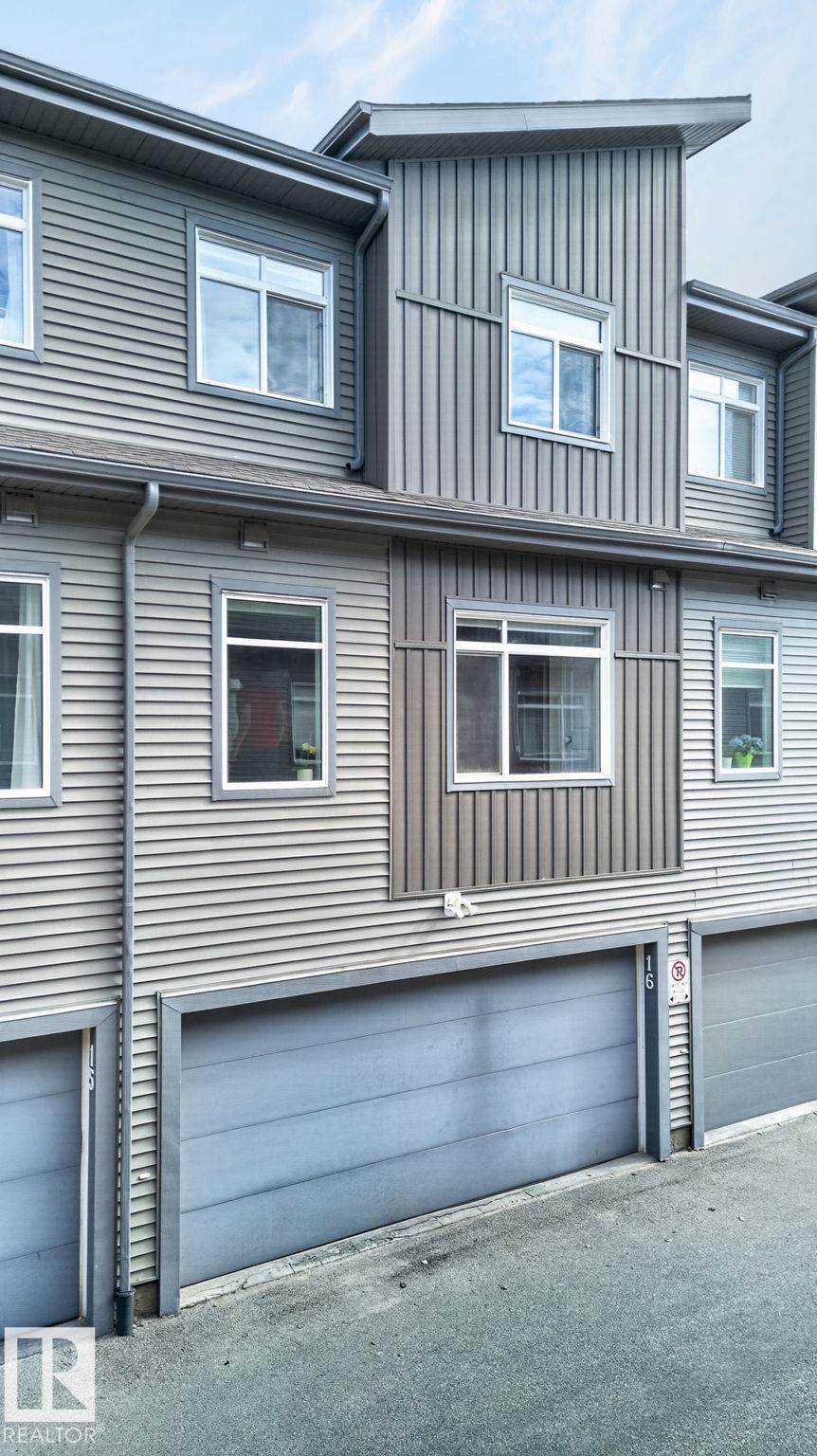 Contemporary multi-level exterior featuring horizontal and vertical siding - 16 7503 Getty Gate, Edmonton, AB - Outdoor