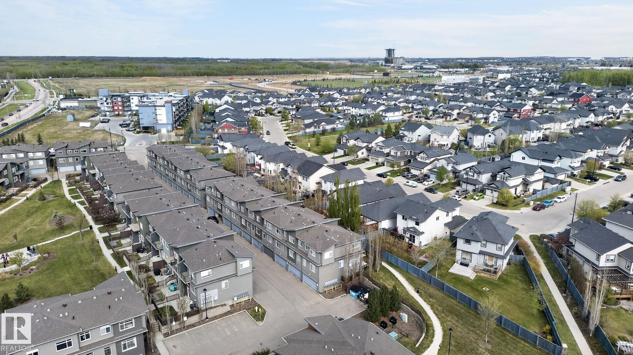 Aerial perspective showcasing a residential development with varied housing types - 16 7503 Getty Gate, Edmonton, AB - Outdoor With View