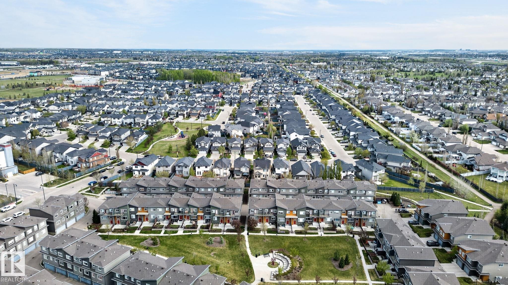 Aerial perspective showcasing a residential community with varied housing styles - 16 7503 Getty Gate, Edmonton, AB - Outdoor With View