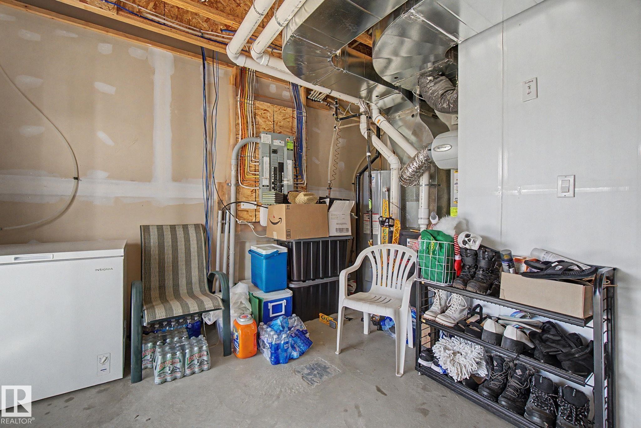 Utility area featuring exposed wood framing, drywall-finished walls, and visible ductwork - 17 320 Secord Boulevard, Edmonton, AB - Indoor Photo Showing Basement