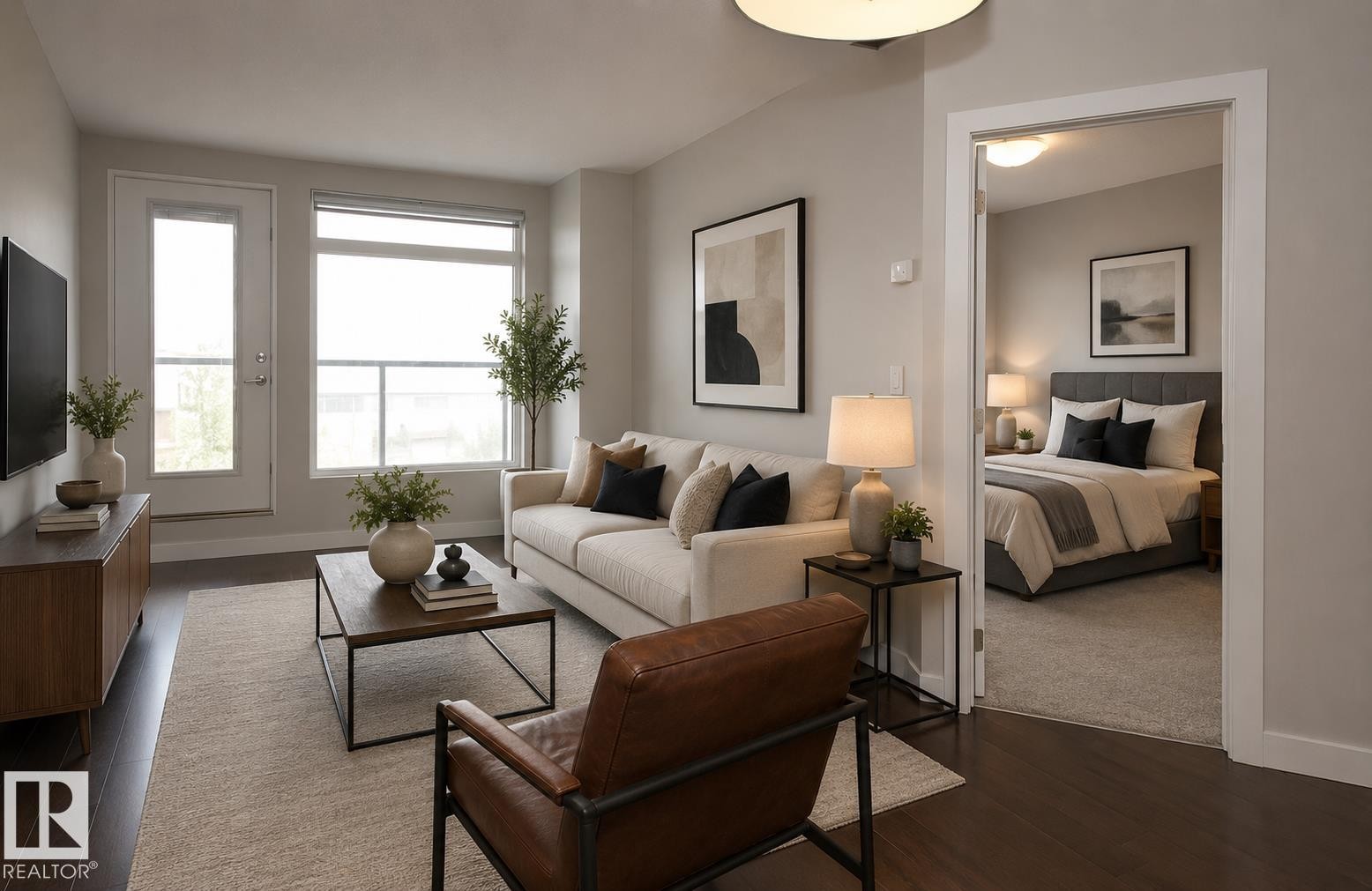 Living area featuring dark wood-finish flooring, light-toned walls, a glass-paneled door, and a large window - 531 5151 Windermere Boulevard, Edmonton, AB - Indoor Photo Showing Living Room