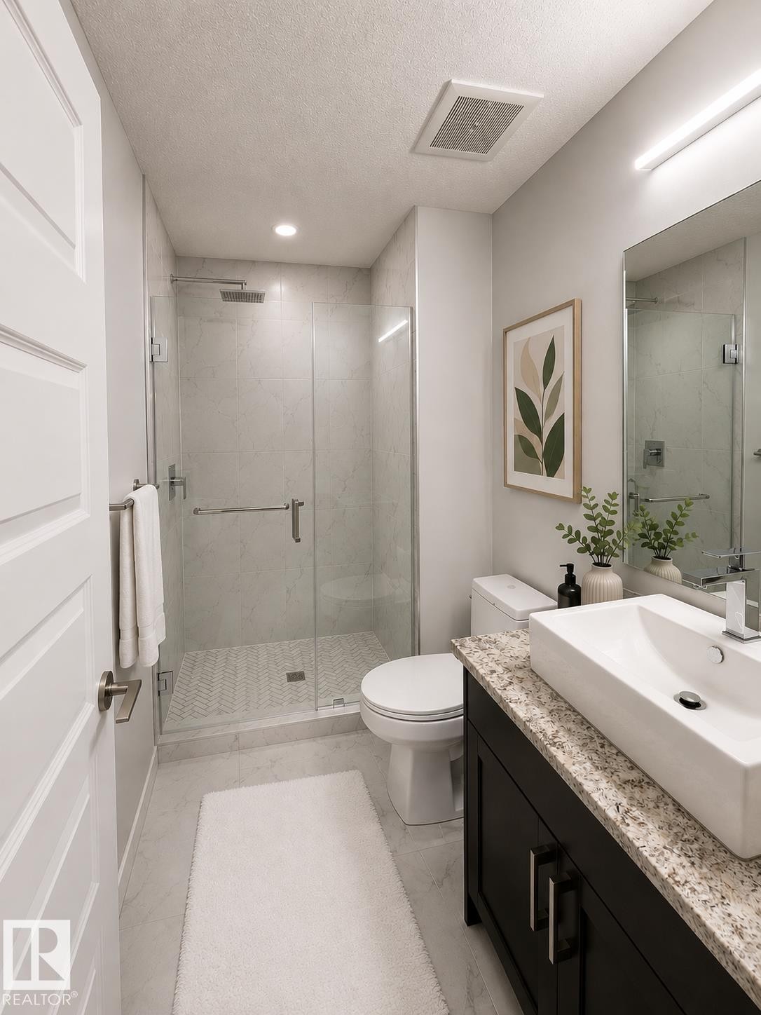 Walk-in shower with clear glass enclosure and herringbone tile flooring - 531 5151 Windermere Boulevard, Edmonton, AB - Indoor Photo Showing Bathroom