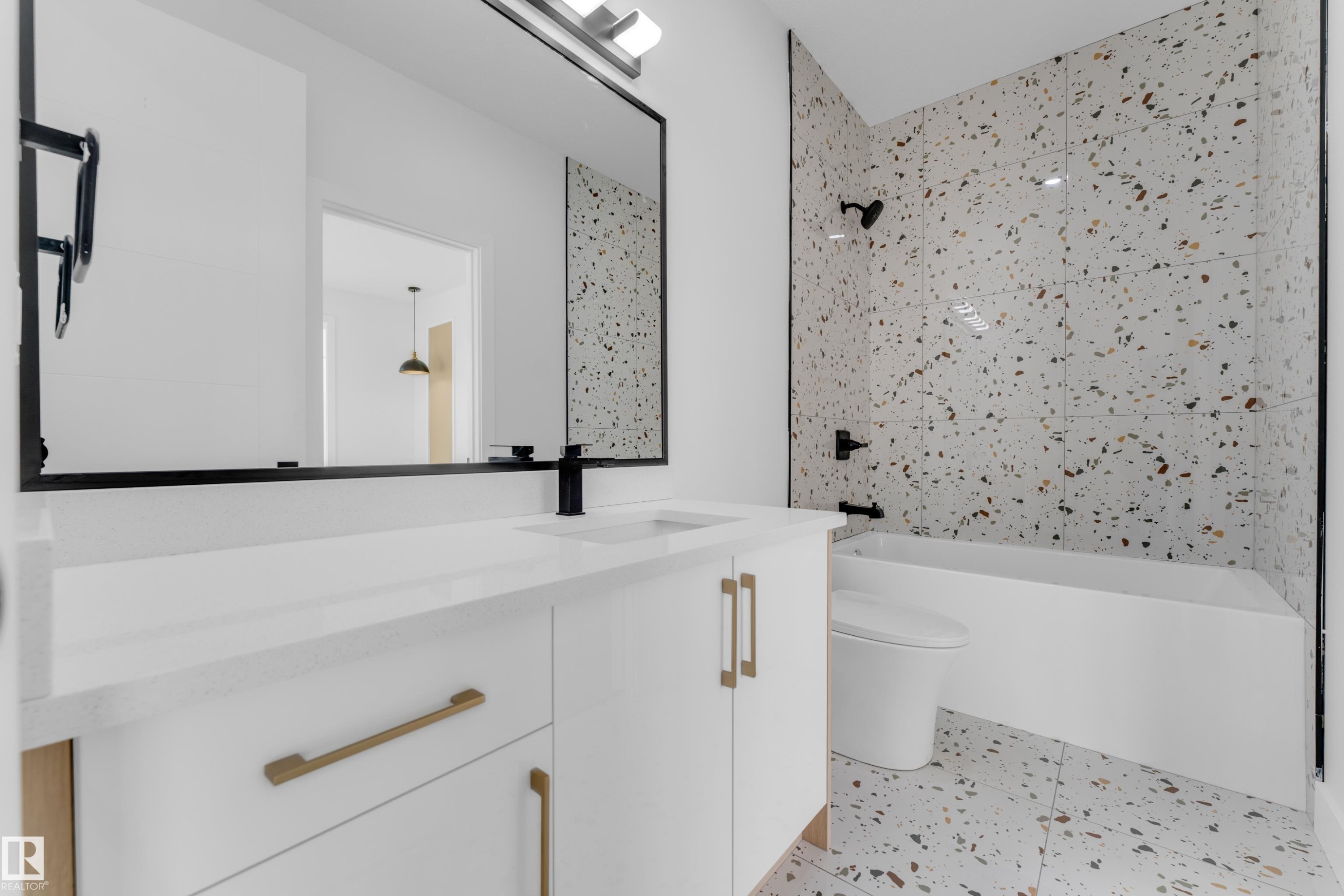 Bathroom featuring a white vanity with gold-tone hardware, a rectangular undermount sink, and a matte black faucet - 449 Crystal Creek Link, Leduc, AB - Indoor Photo Showing Bathroom