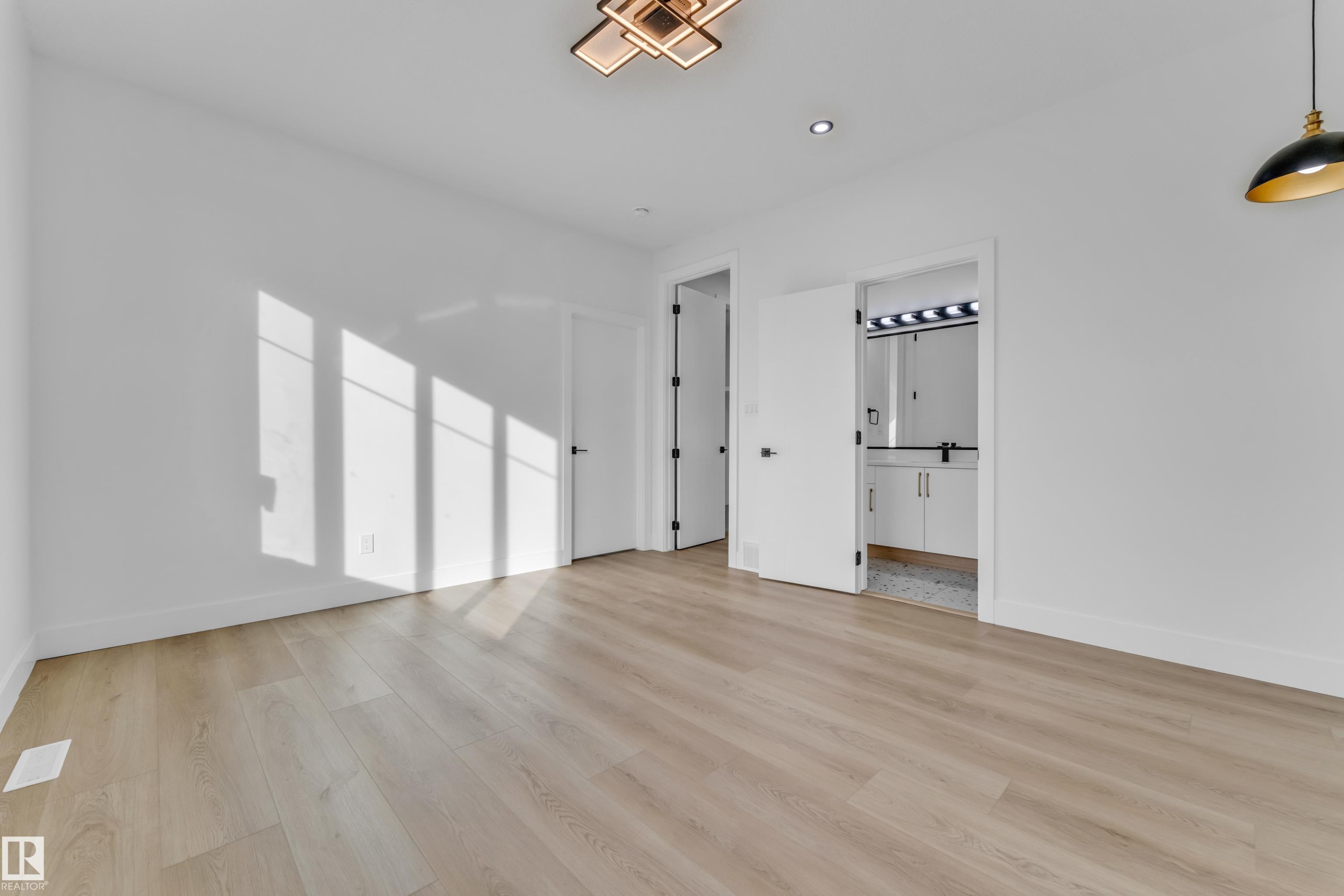 Light wood-finish flooring complements the neutral wall tones - 449 Crystal Creek Link, Leduc, AB - Indoor Photo Showing Other Room