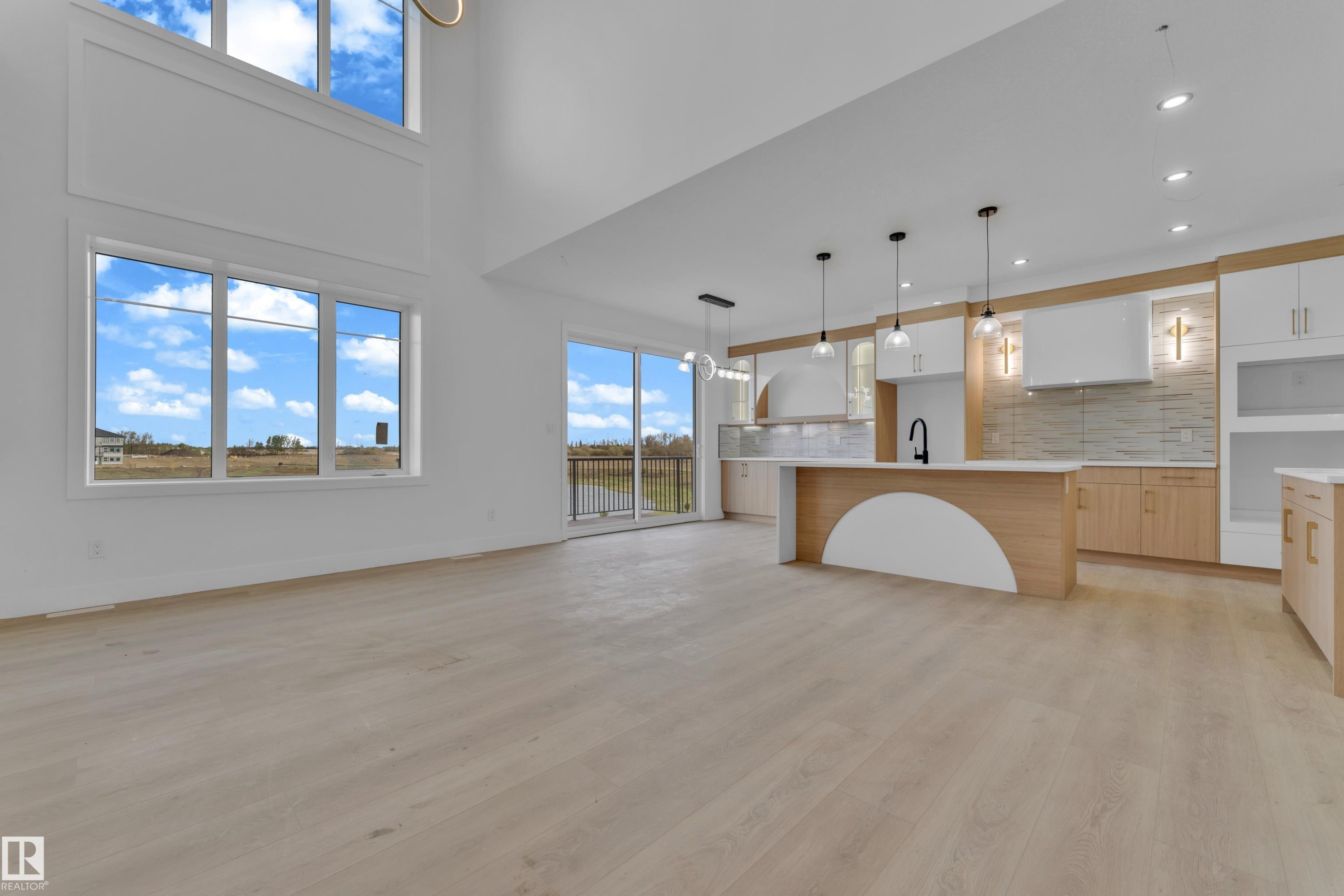 Expansive open-concept living space with high ceilings and wood-finish flooring - 449 Crystal Creek Link, Leduc, AB - Indoor Photo Showing Kitchen