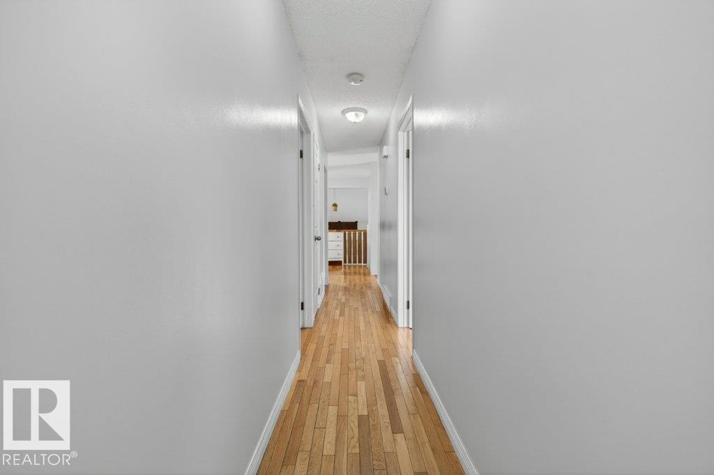 Hallway with wood-finish flooring, light gray walls, and recessed lighting - 157 Kiniski Crescent, Edmonton, AB - Indoor Photo Showing Other Room