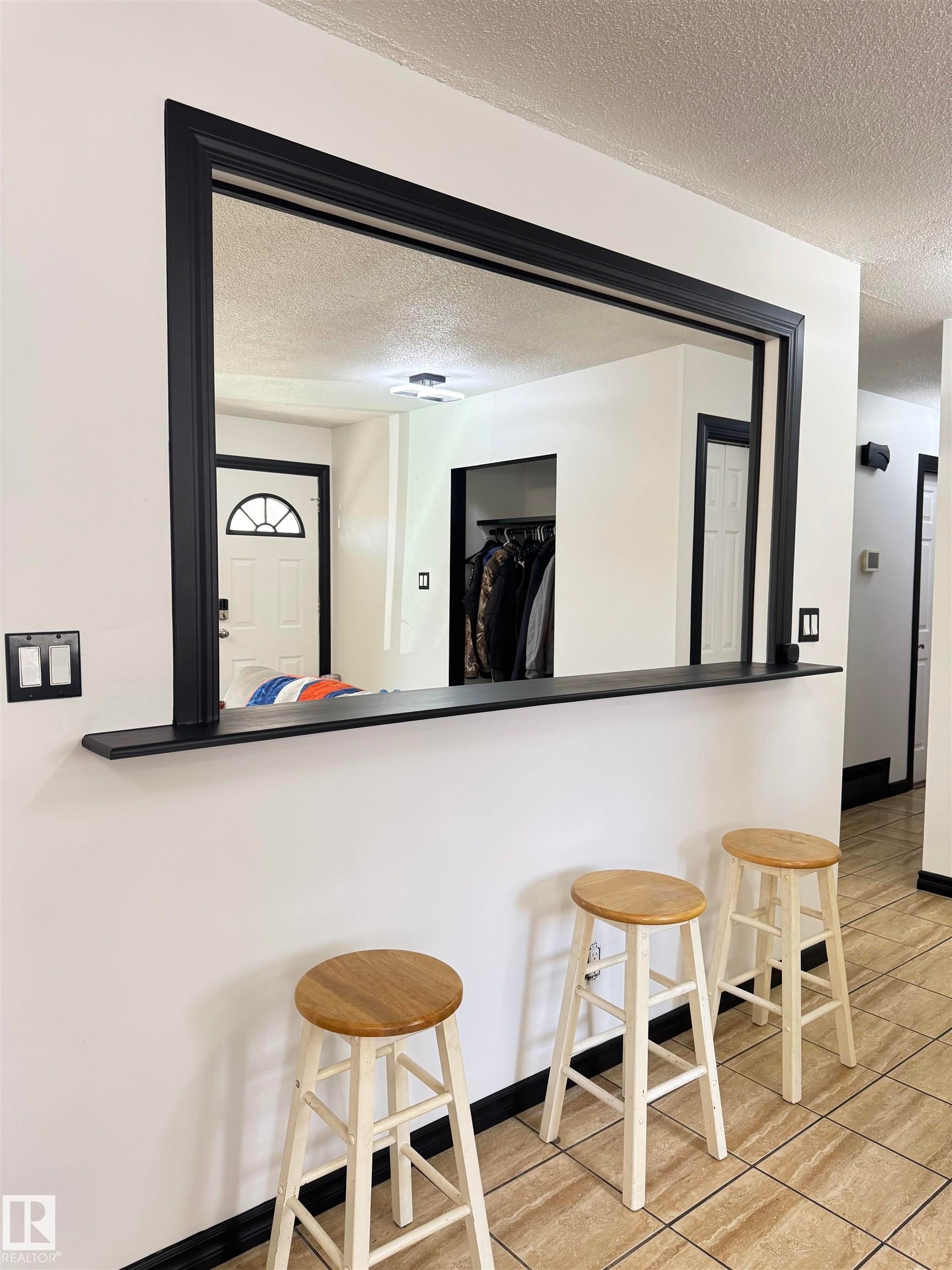 Pass-through window with black trim, integrated shelf, and tile flooring - 45 Lambert Crescent, St. Albert, AB - Indoor