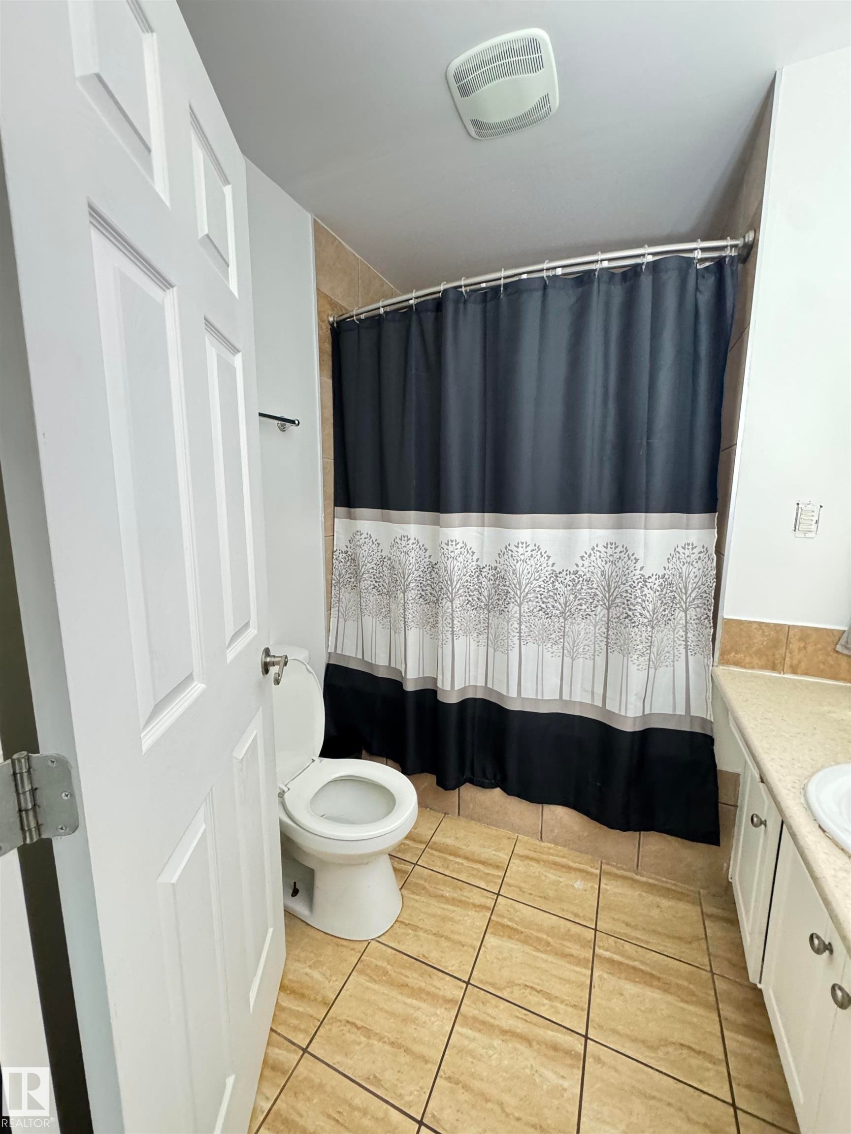 Bathroom featuring light-toned tile flooring and a neutral vanity with an integrated sink - 45 Lambert Crescent, St. Albert, AB - Indoor Photo Showing Bathroom