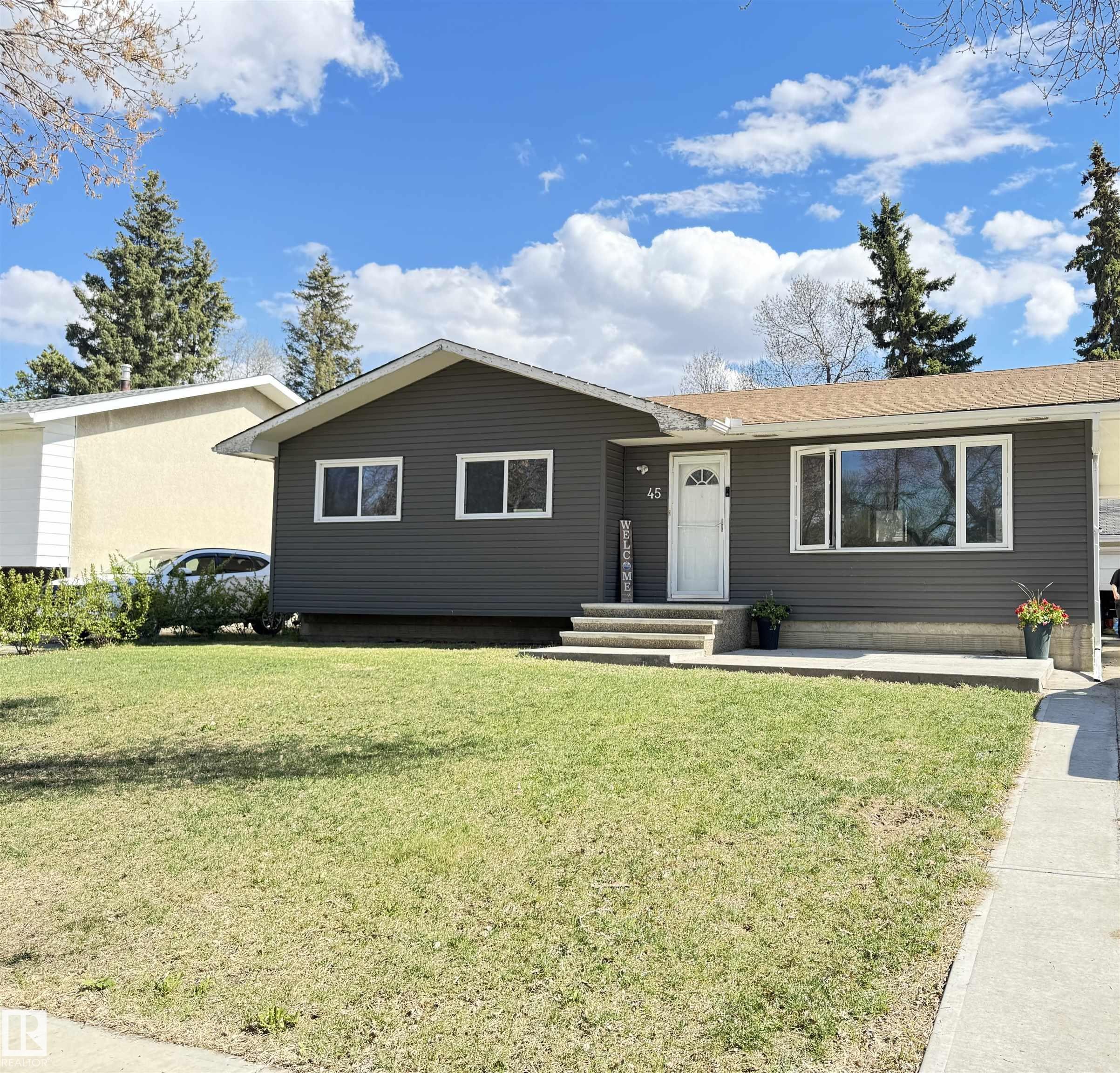 Ranch-style residence featuring dark gray horizontal siding and a light brown shingle roof - 45 Lambert Crescent, St. Albert, AB - Outdoor